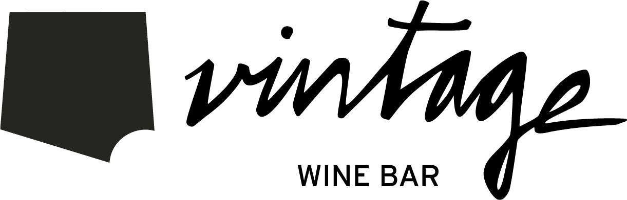 A person in a dark room, partially illuminated, holding some papers or a book.