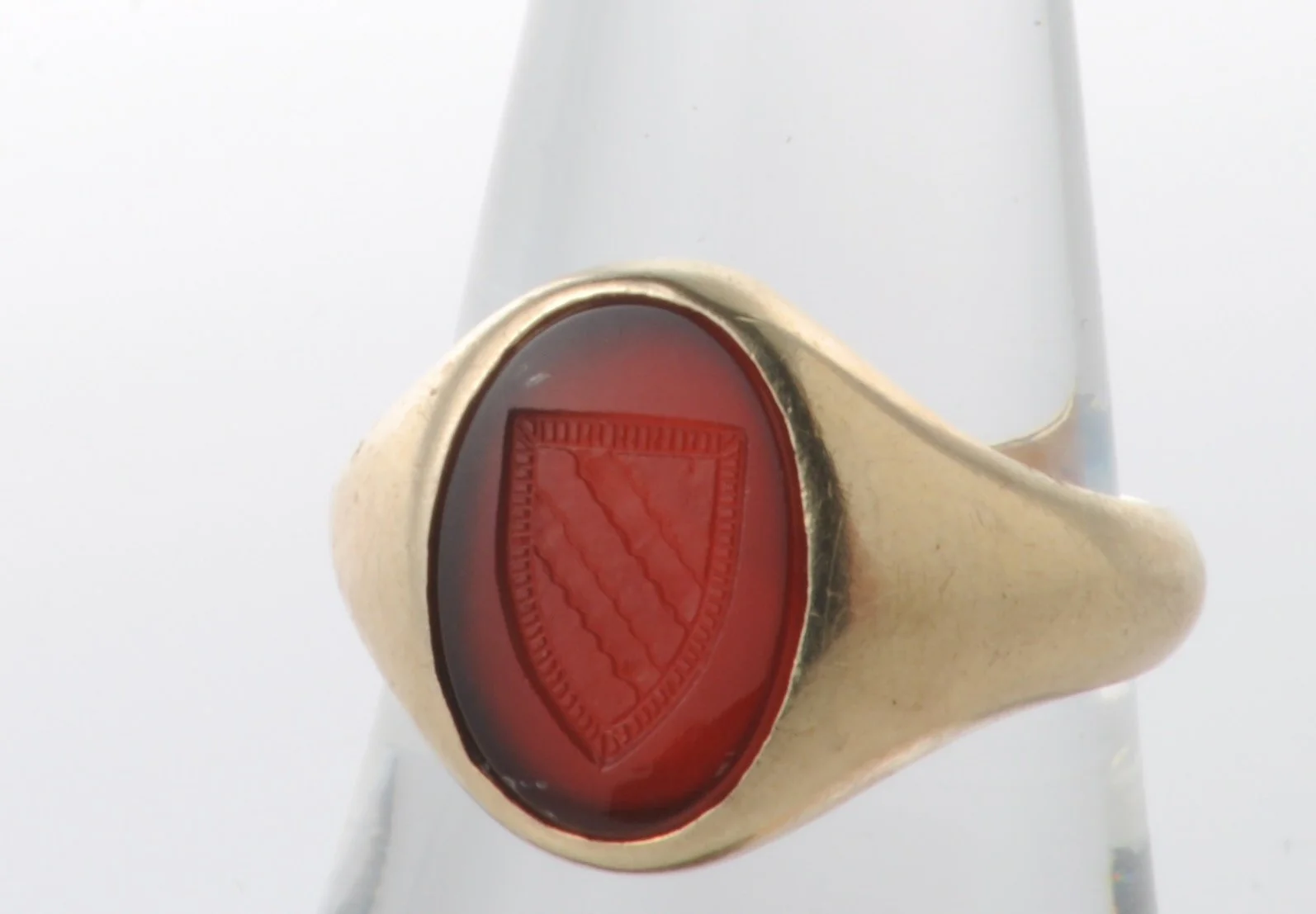 10k yellow gold ring set with carved carnelian stone with engraved shield. 4.8 dwt.