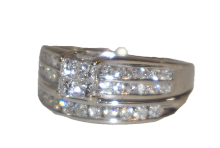 A 14K WHITE GOLD WEDDING SET, SOLDERED TOGETHER WITH THE ENGAGEMENT RING, HAVING 4 PRINCESS CUT CENTER DIAMONDS AND 24 ROUND BRILLIANT CUT DIAMONDS IN THE
SHANK. RETAIL REPLACEMENT COSTS: $3,000.00 