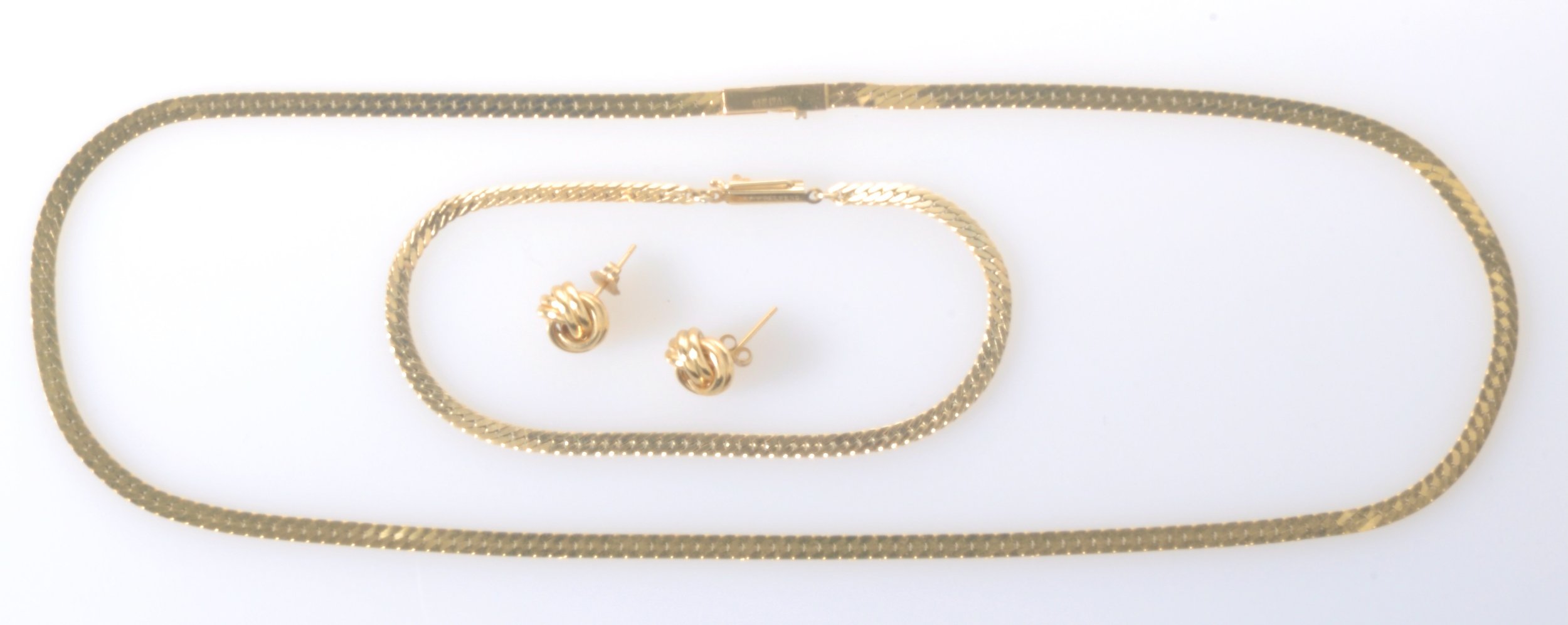 14k yellow gold herringbone necklace and bracelet, made in Italy. Gold knot earrings.