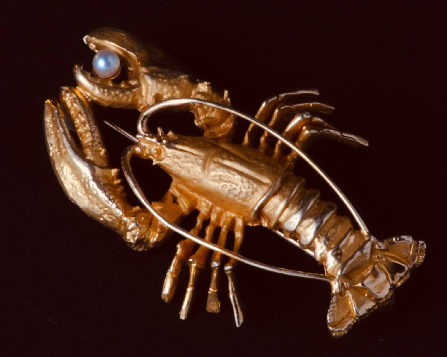 18k yellow gold lobster brooch by Springers, weighing 5.7dwt.