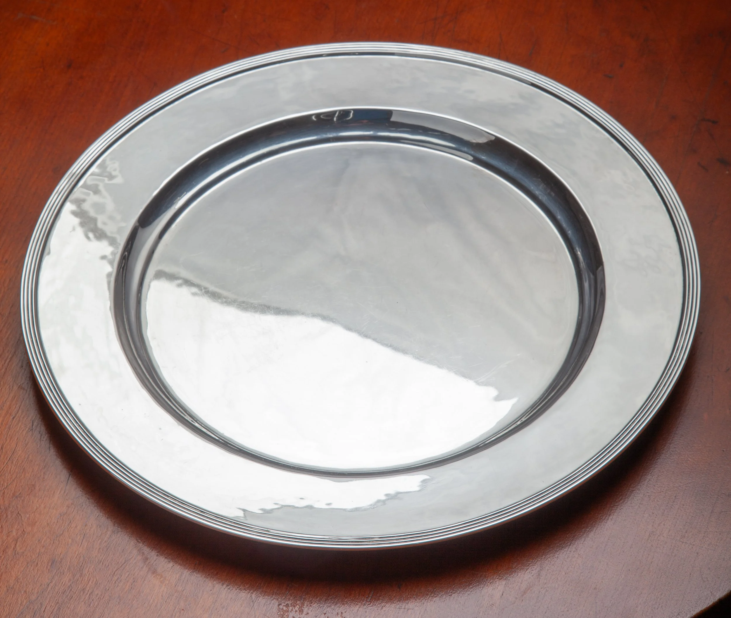 A 10 1/4TH INCH DIAMETER, STERLING SILVER, ROUND, DEEP PLATE, #226, BY KARL LEINONEN OF BOSTON, WEIGHING 17.47 OZS. STERLING SILVER. HE WAS IN CHARGE OF THE BOSTON SOCIETY OF ARTS & CRAFTS AND WELL KNOWN FOR HIS EXCELLENT WORK