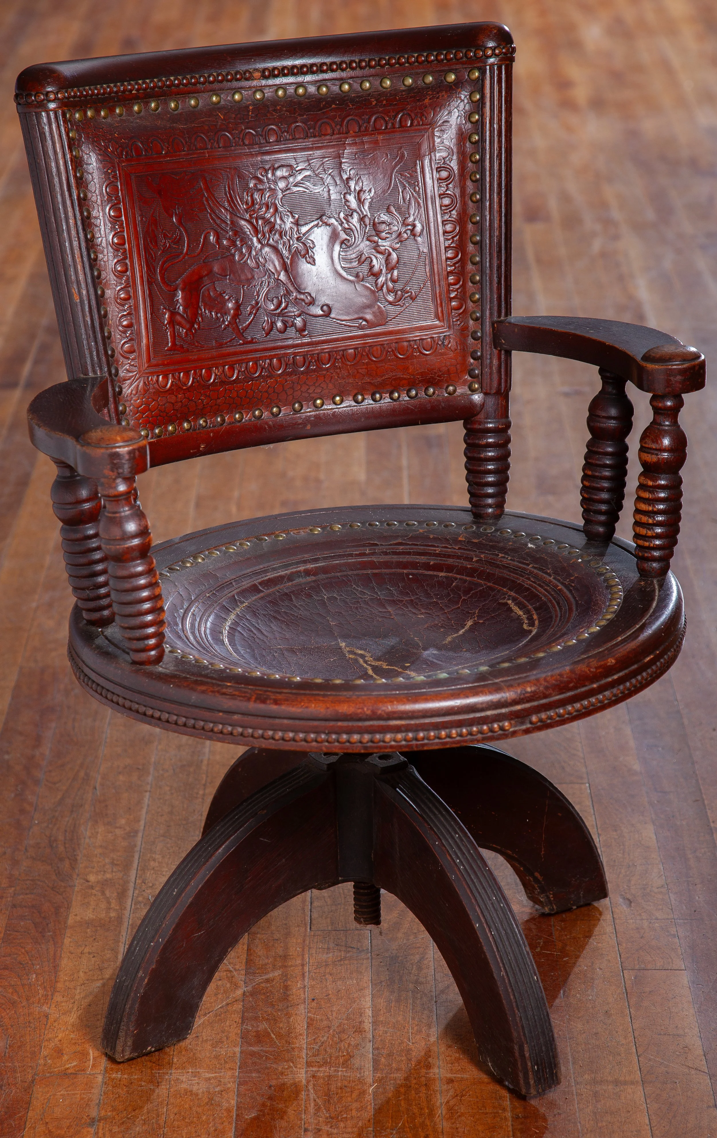 A VICTORIAN WALNUT, SWIVEL, ARMCHAIR WITH ORIGINAL LEATHER PADS, ONCE USED IN THE MAINE STATE LEGISLATIVE CHAMBER