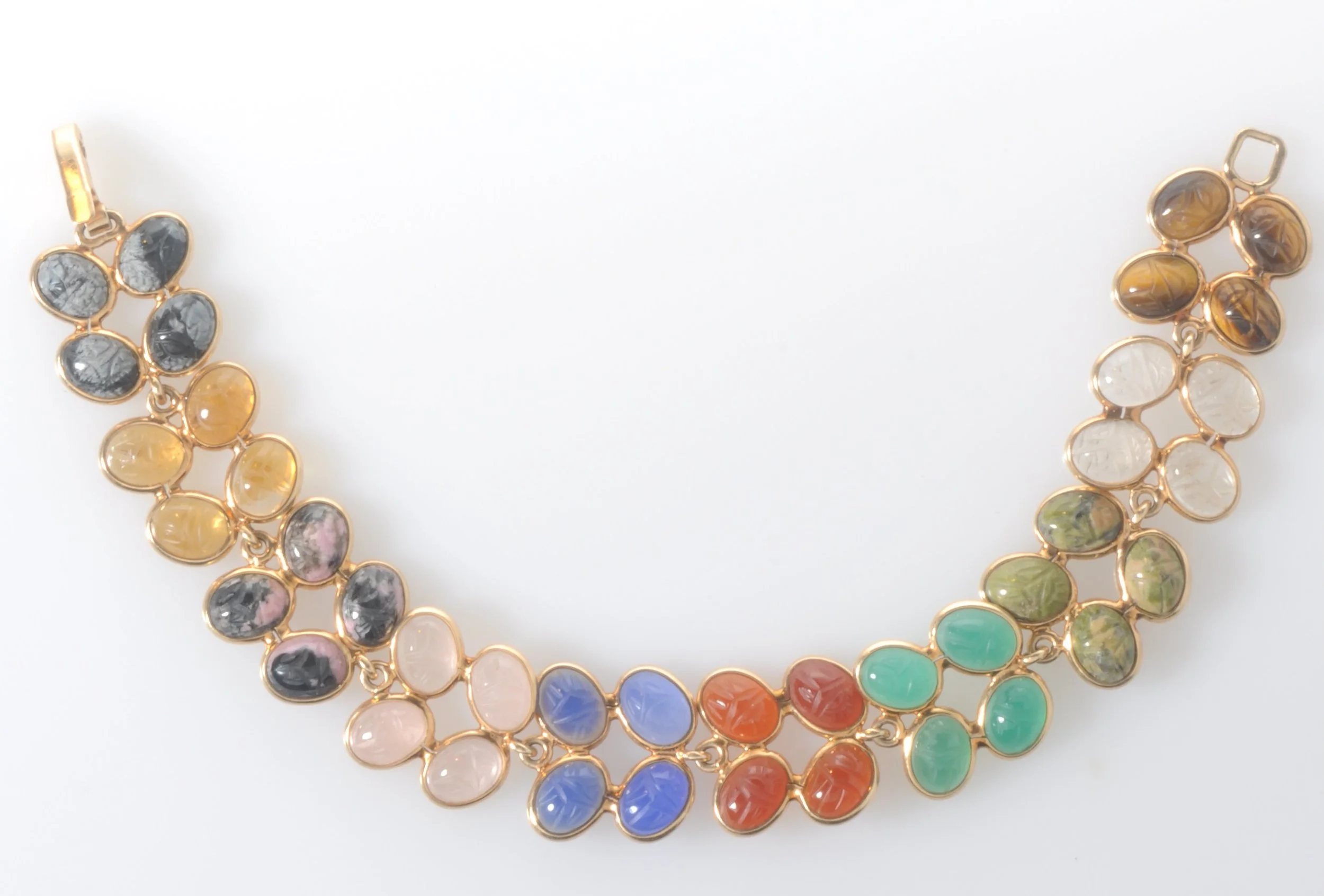 14k yellow gold multi stone scarab line bracelet with Tiger's eye, Rock crystal Quartz, Unakite, green Chalcedony, blue Chalcedony, Carnelian, Rose Quartz, Rhodonite, Citrine, snowflake Obsidian. Over 40 carved scarabs with a total carat weight of 46