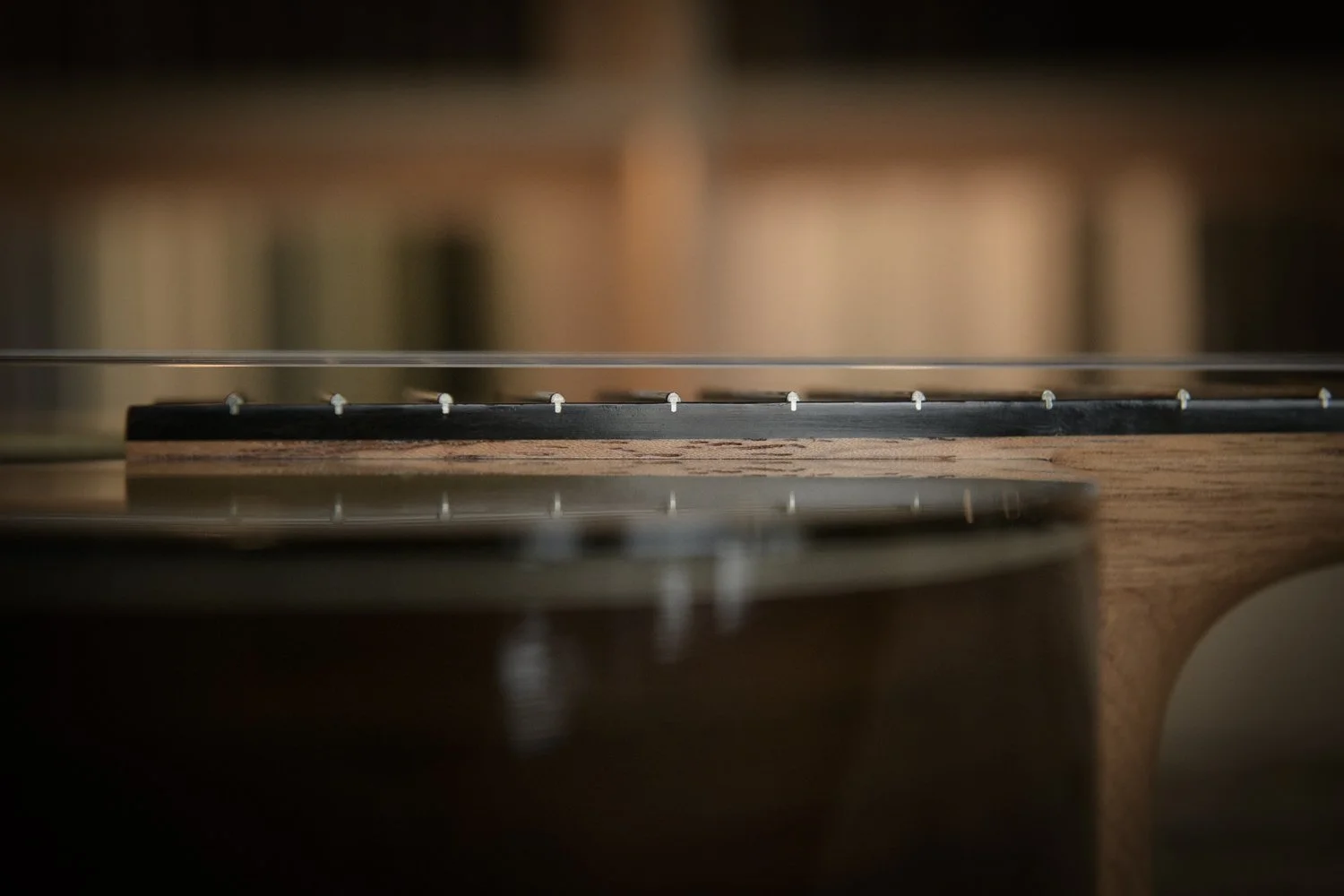 Close-up of the strings and fretboard of an acoustic guitar.