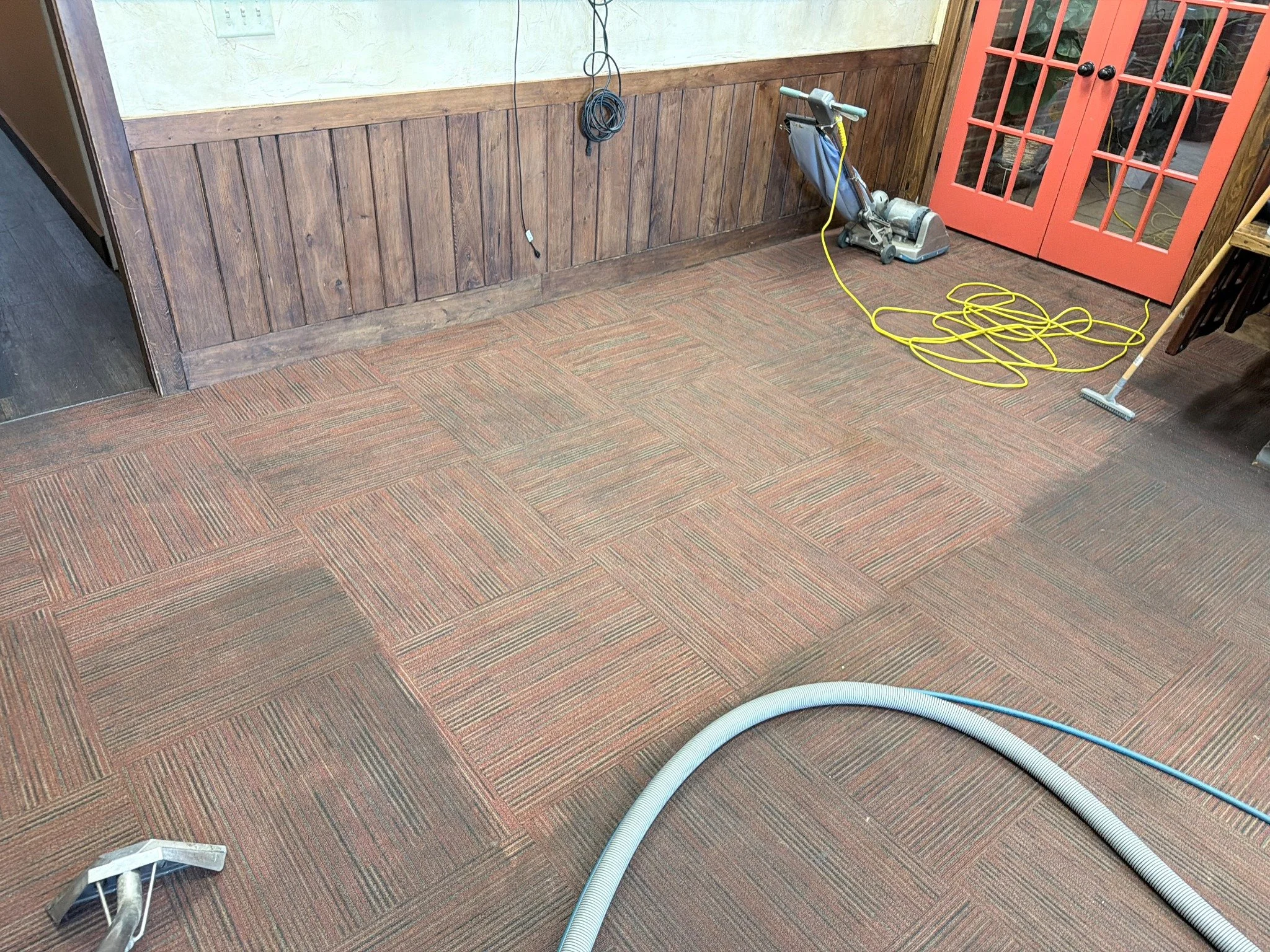 Restaurant carpet cleaning — before & after project. Carpet extraction equipment at work in the dining room.