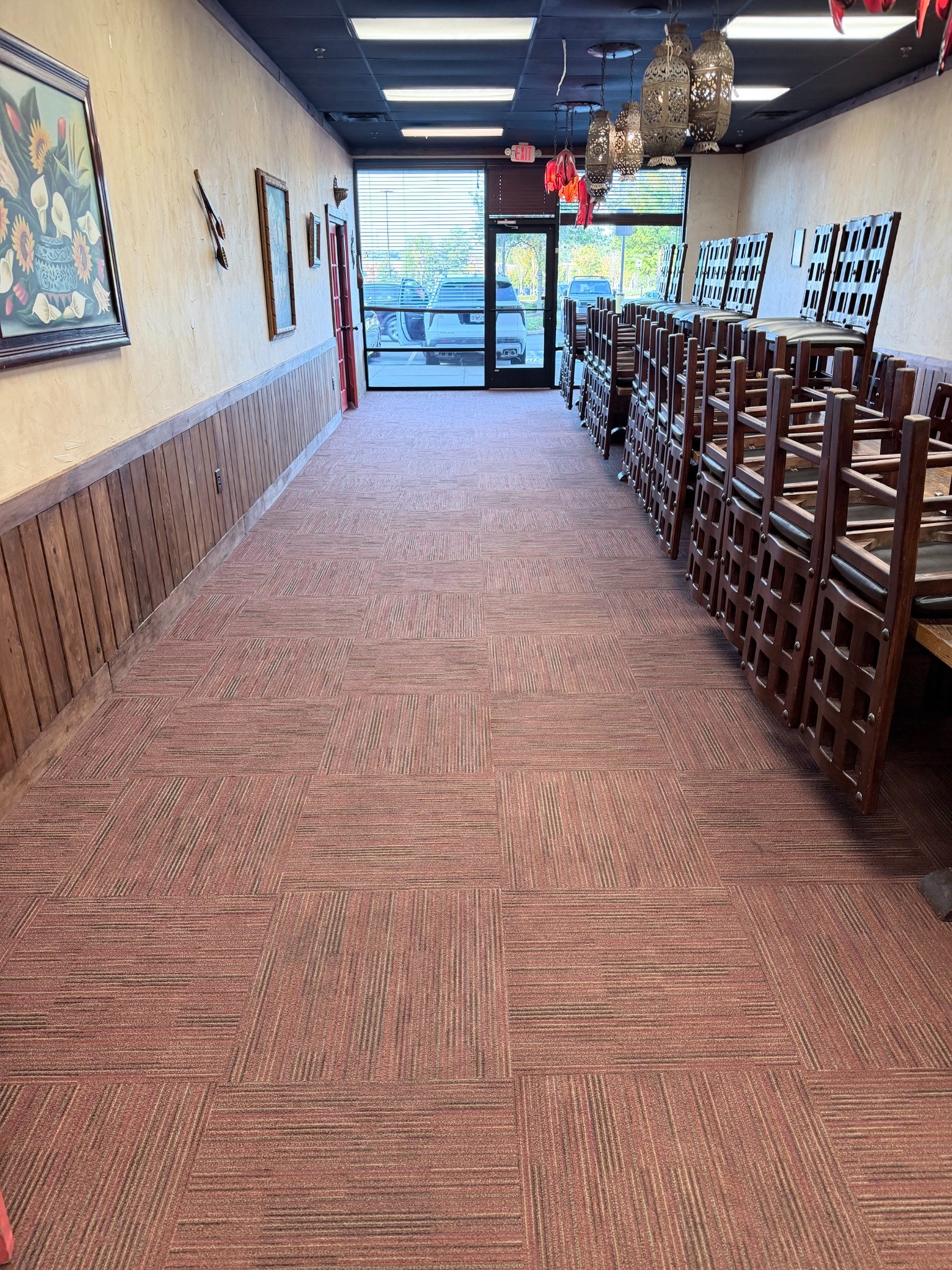 Restaurant carpet cleaning — before & after project. Finished dining-room carpet with chairs raised.