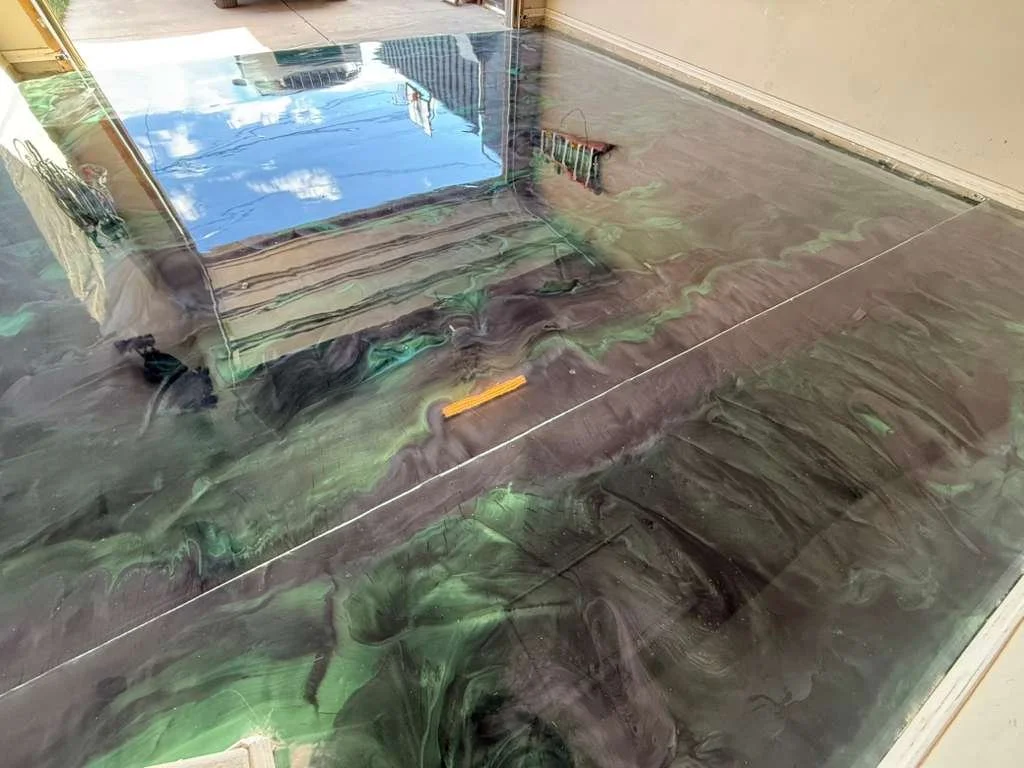 Cracked marble floor with a tool lying on it, reflecting the sky and surroundings in the marble's polished surface.