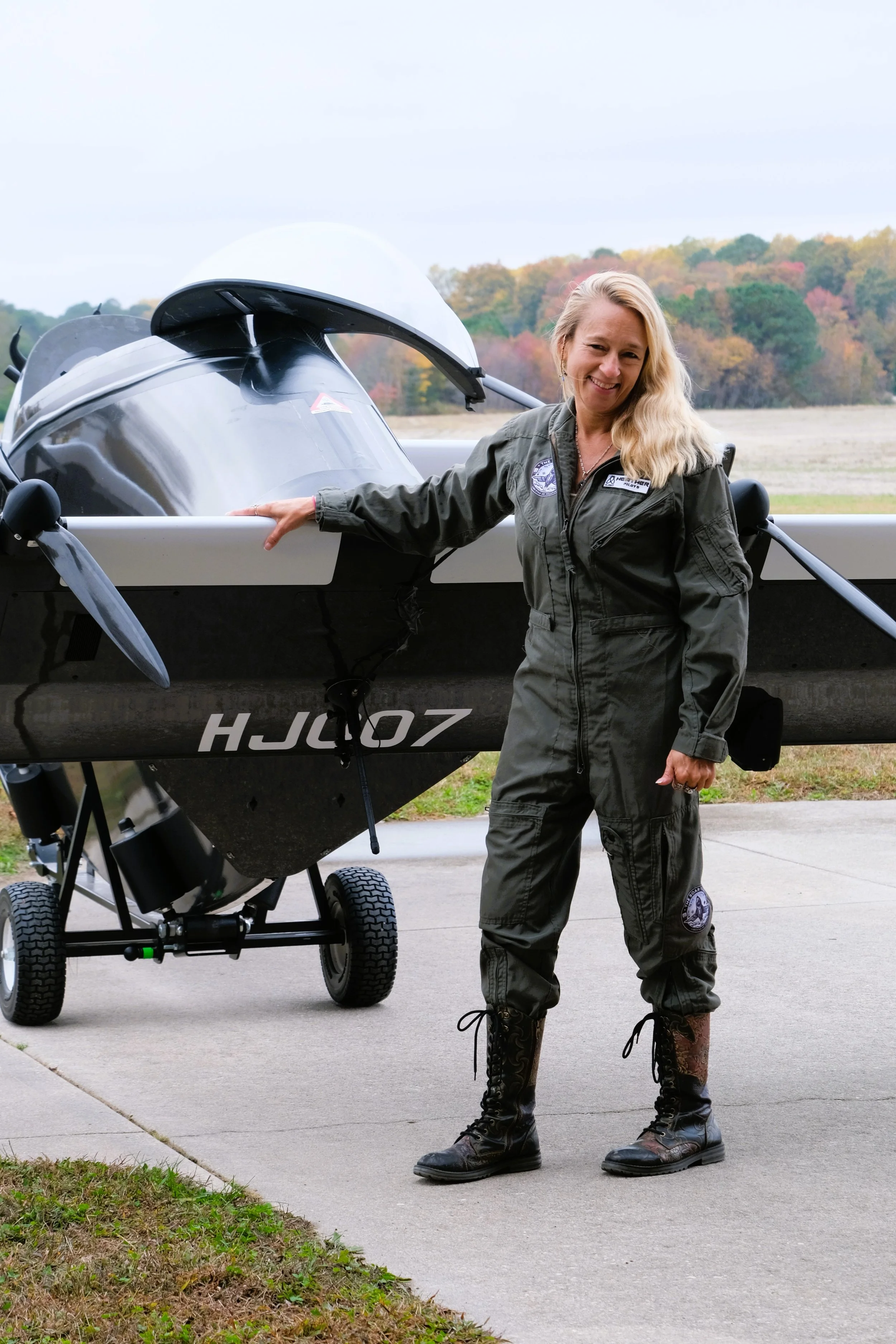 Heather Chirtea, the nation's first female flying car pilot, hangs out in front of the nation's first flying car, the BlackFly HJ007.