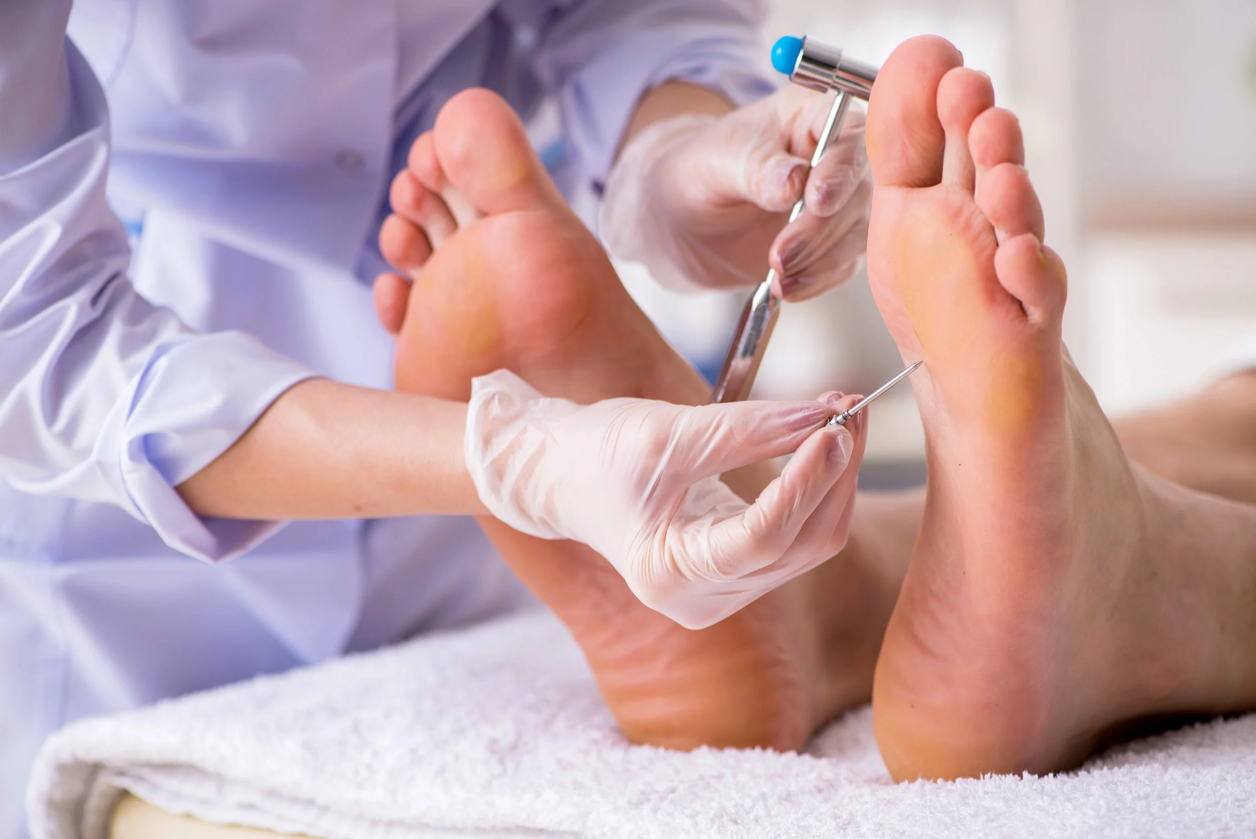 Podiatrist examining a patients foot and ankle