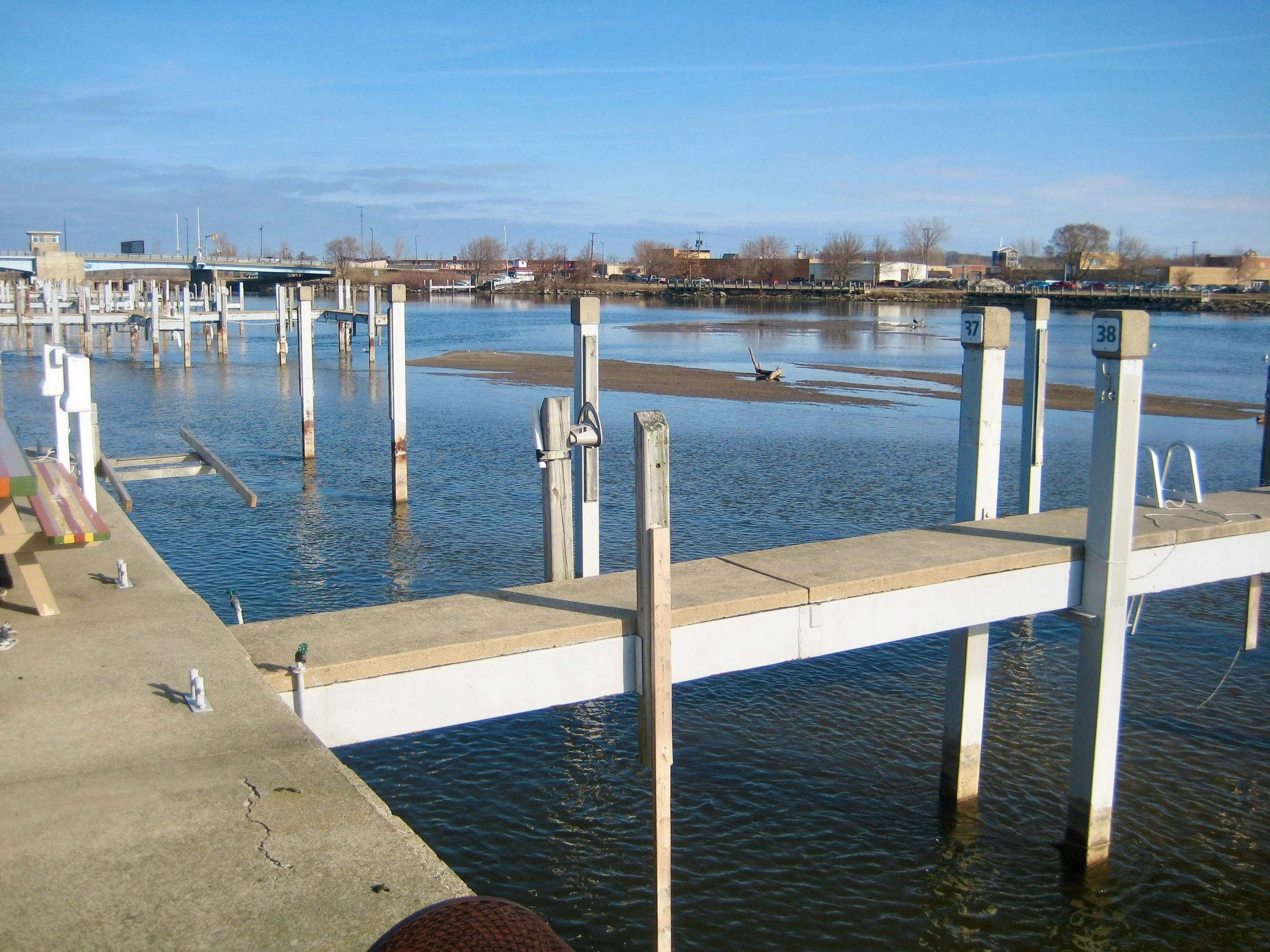 Sediment buildup in marina requiring professional dredging to restore safe water depth.