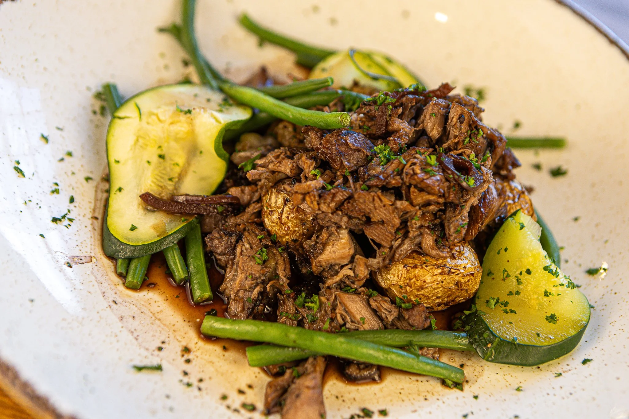 Braised beef with vegetables and potatoes on a plate