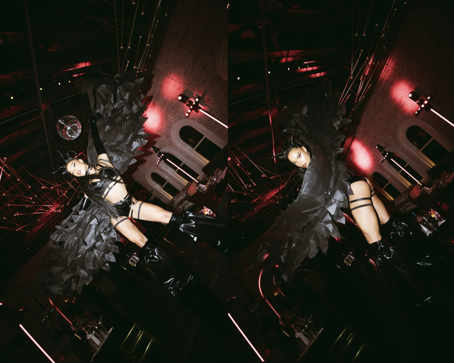 A woman dressed in black latex and leather with thigh straps poses in a dark, red-lit room with artistic decor, a disco ball, and modern lighting.