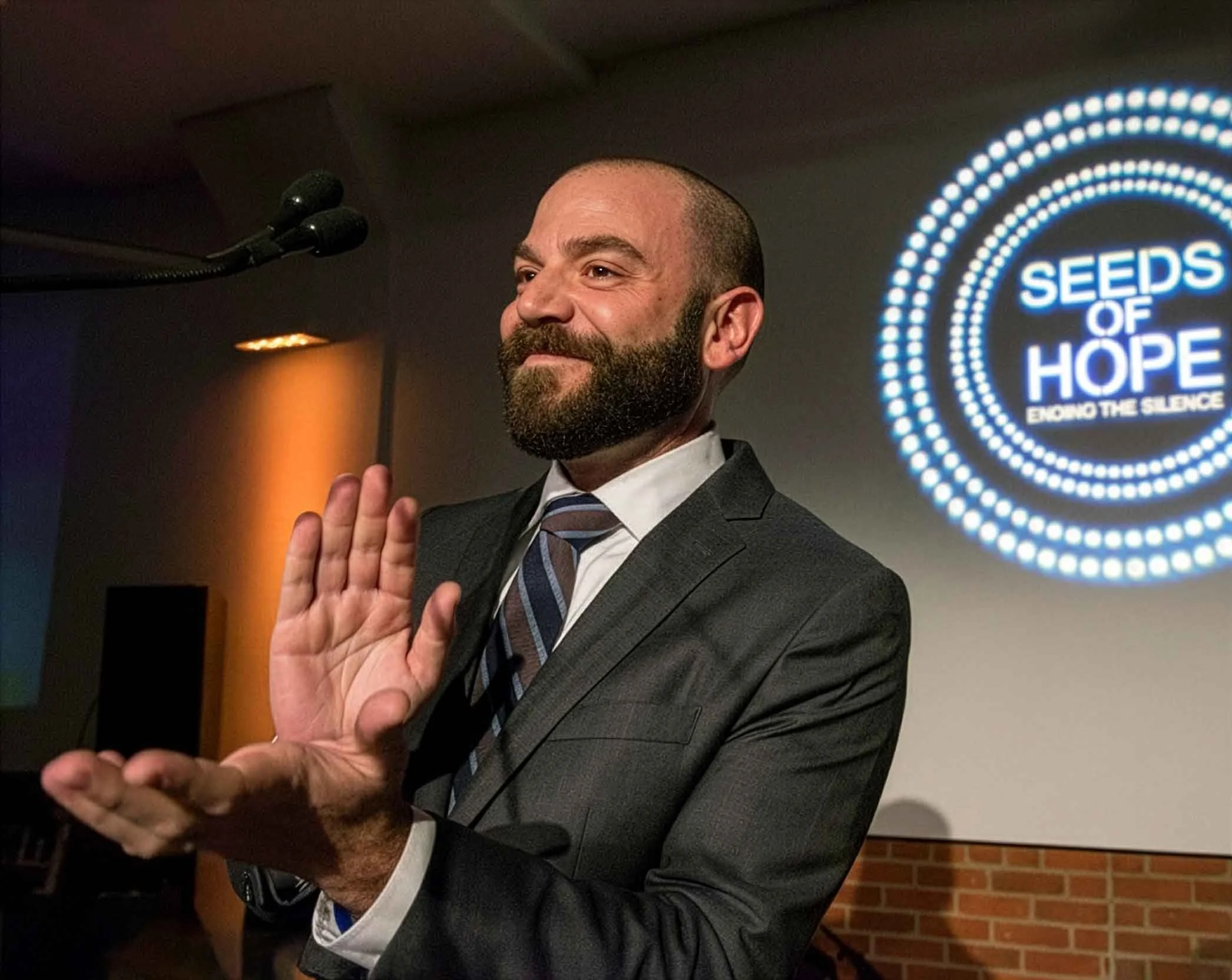 Matt Kudish speaking at a mental health advocacy event on workplace systems and leadership.