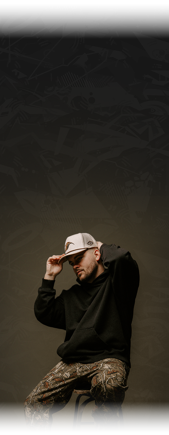 Jake Banfield sitting on barstool adjusting hat