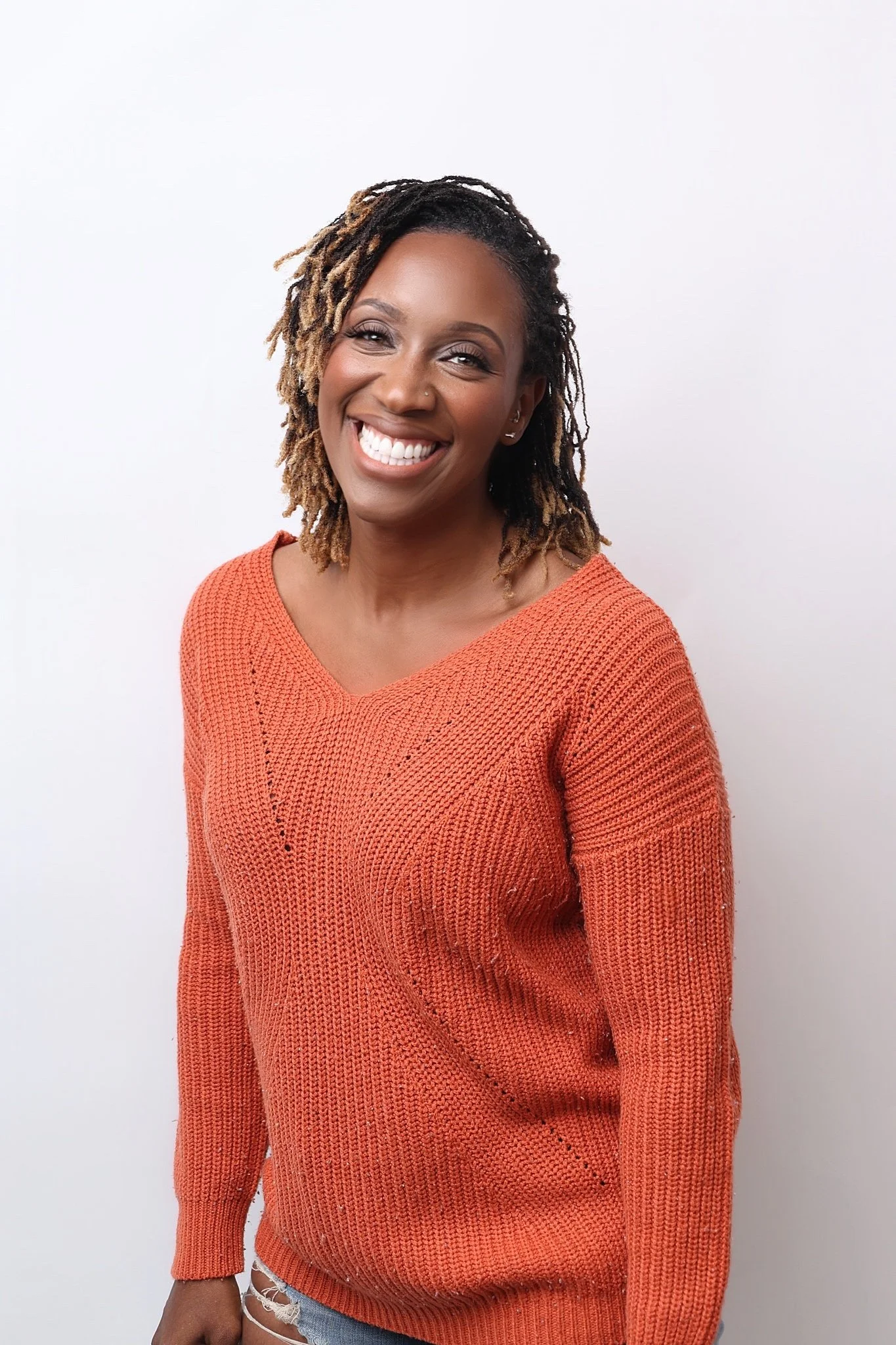 Dr. Ganga Bey in orange sweater