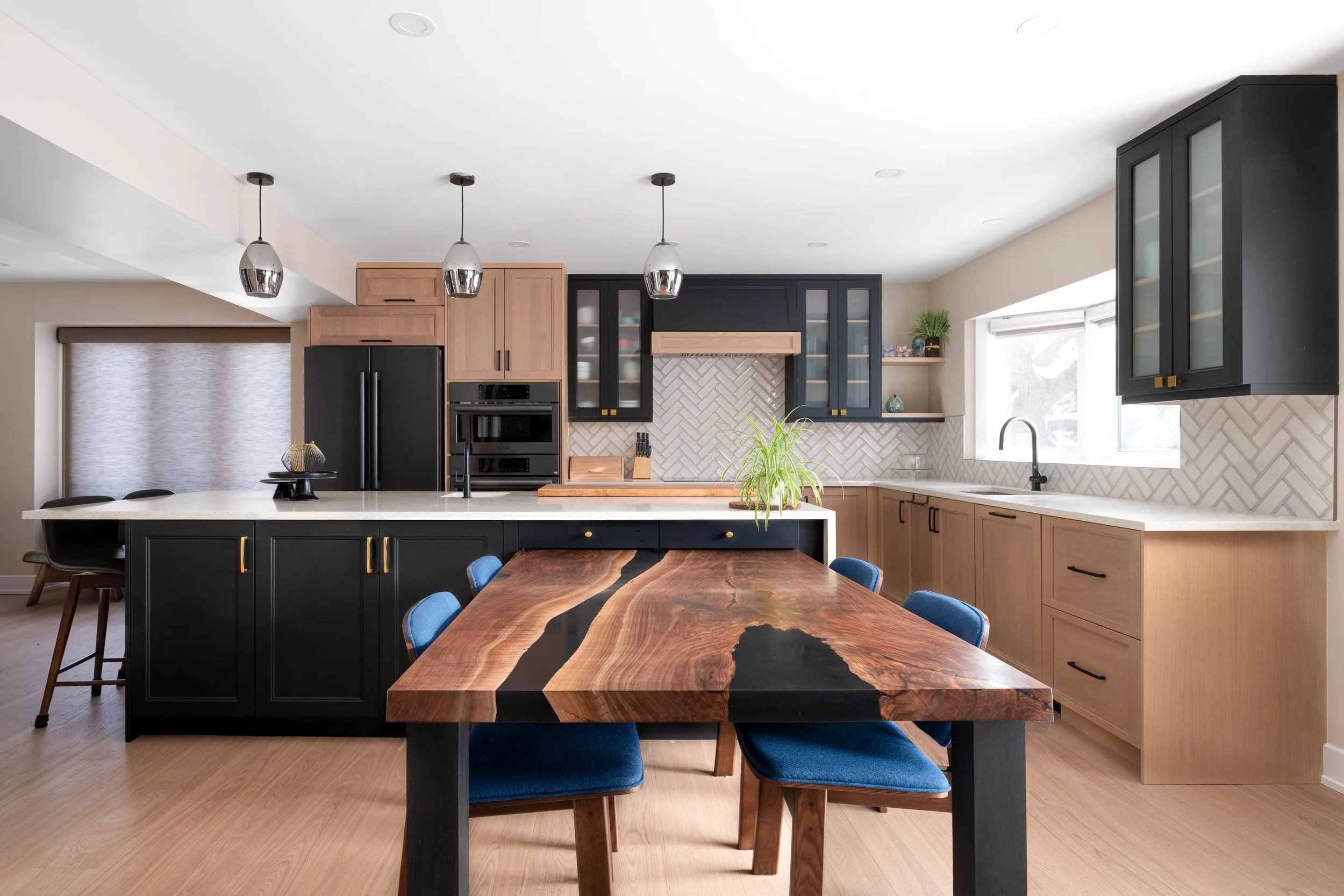 Renovated kitchen with live-edge island and dark cabinetry in a Craig Henry whole-home renovation, Ottawa