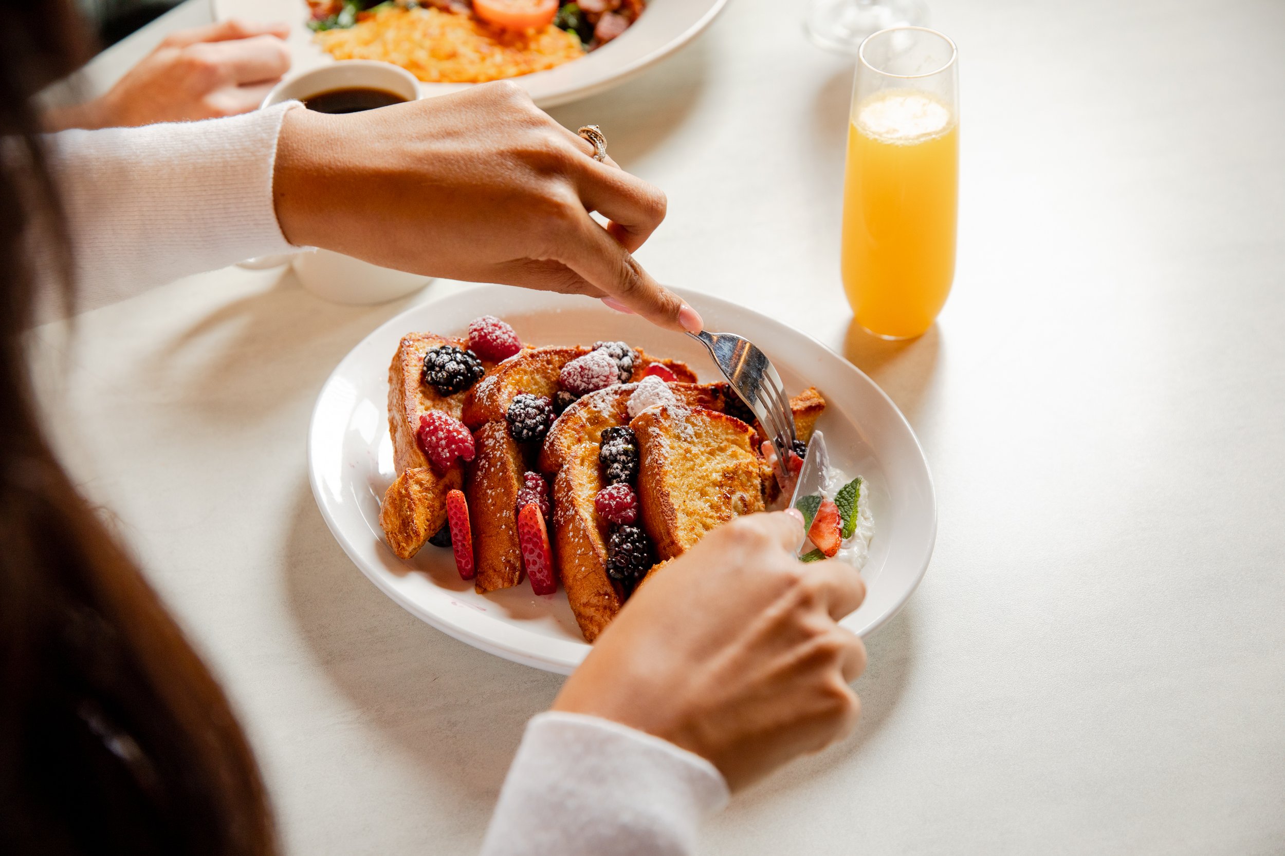 Woman cutting slices of french toast