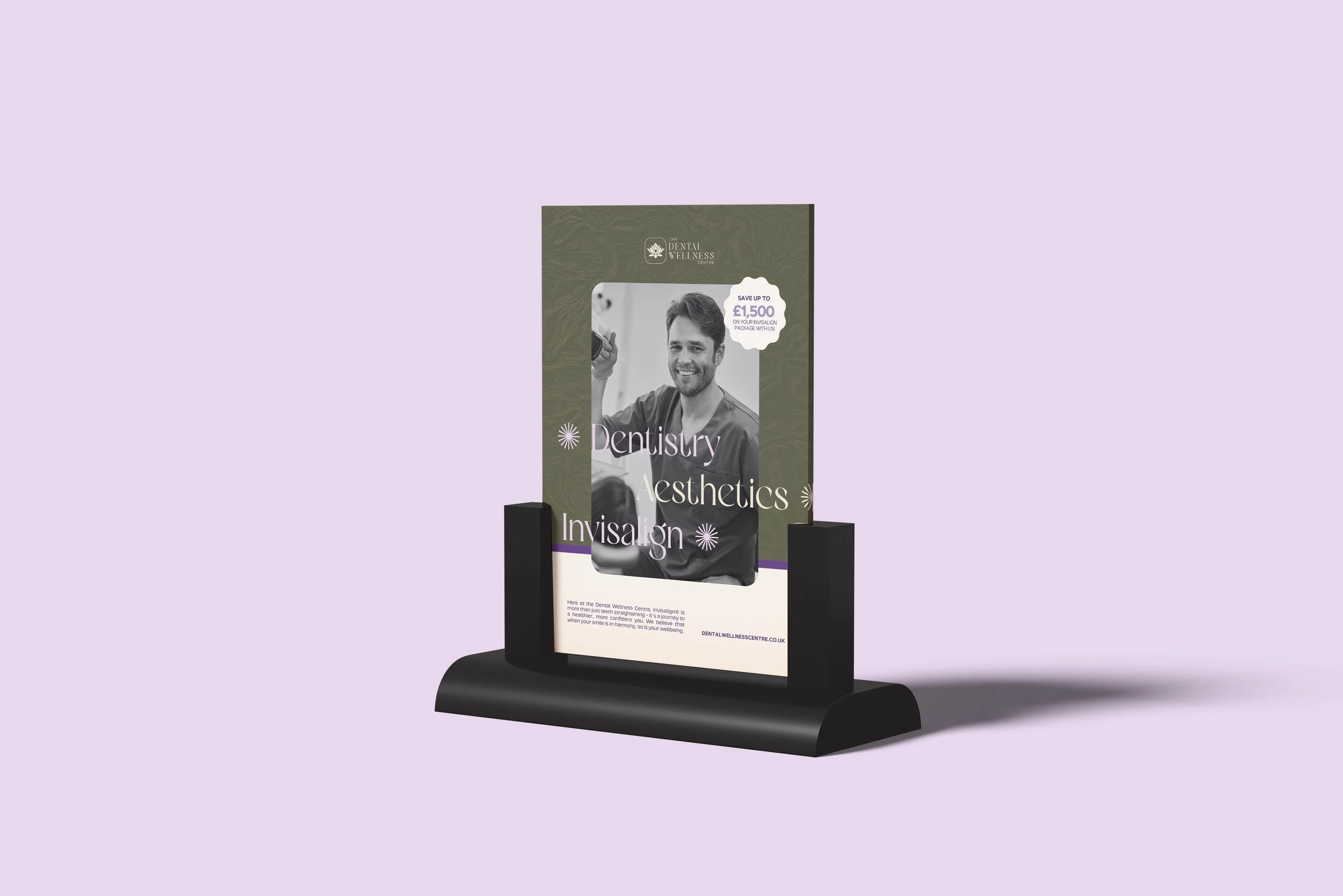 A freestanding advertisement display with a purple background promoting Dentistry Aesthetics and Invisalign services, featuring a smiling man in dental scrubs and promotional text.