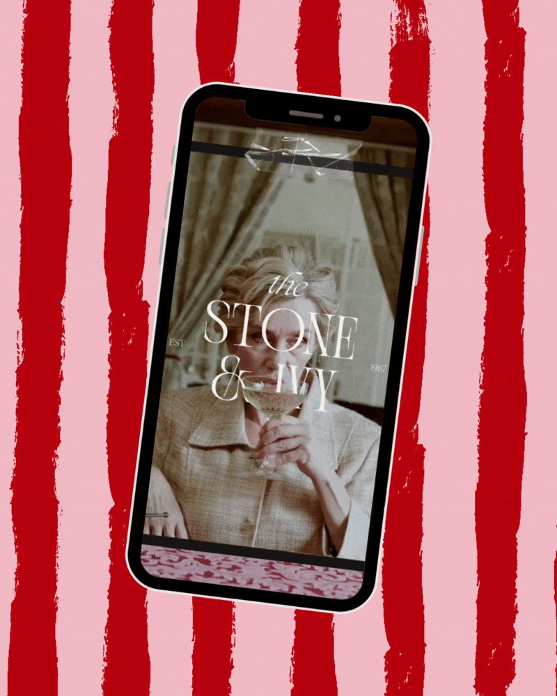 A smartphone displaying a picture of an elderly woman with short gray hair, drinking a glass of white wine, with a decorative curtain in the background, and overlaid text reading "the STONE & IVY".