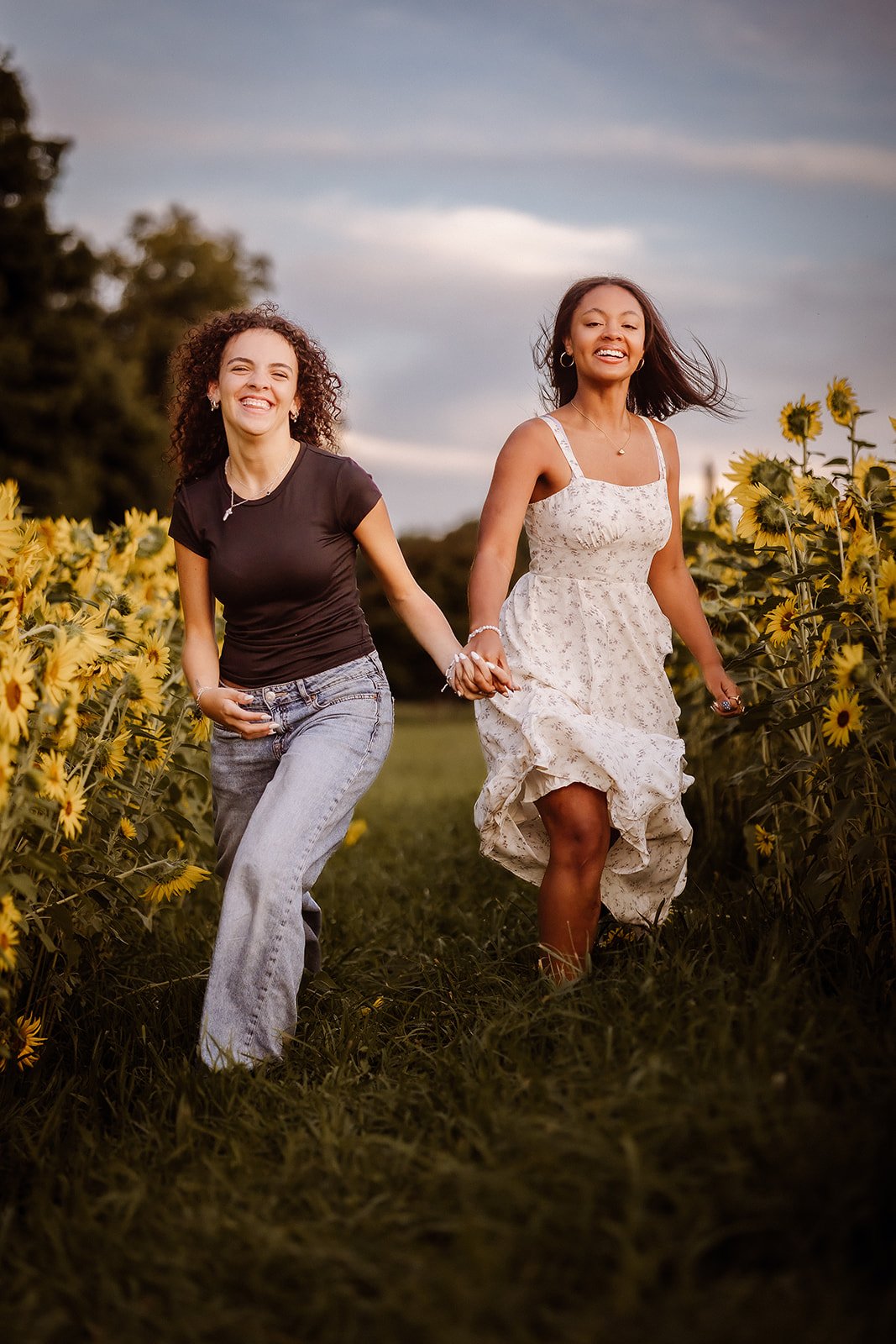 Senior portrait in sunflower field with best friend.