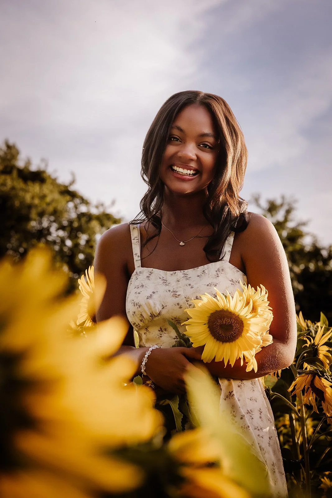 Senior portrait in sunflower field.