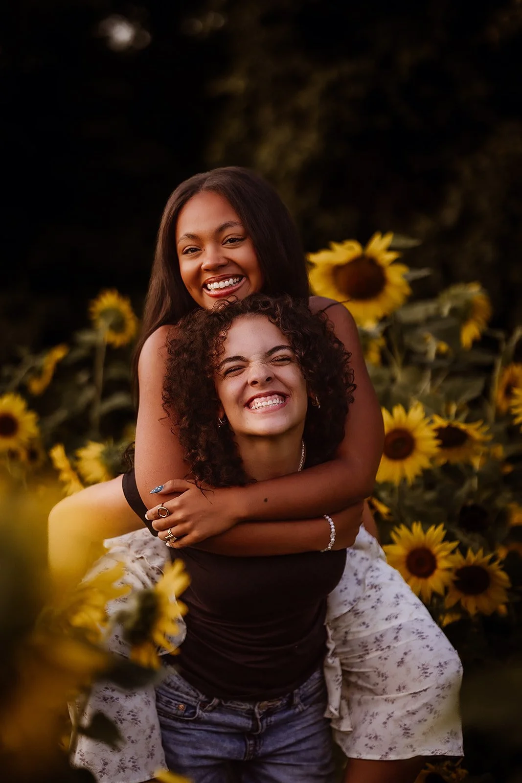 Senior portrait in sunflower field with best friend. 