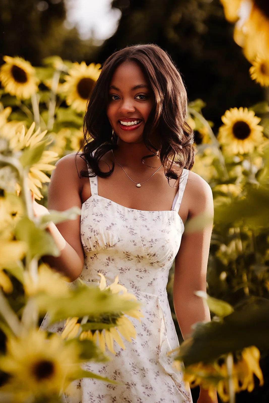 Senior portrait in sunflower field.
