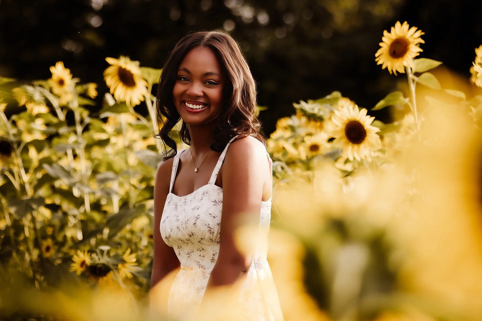 Senior portrait in sunflower field.