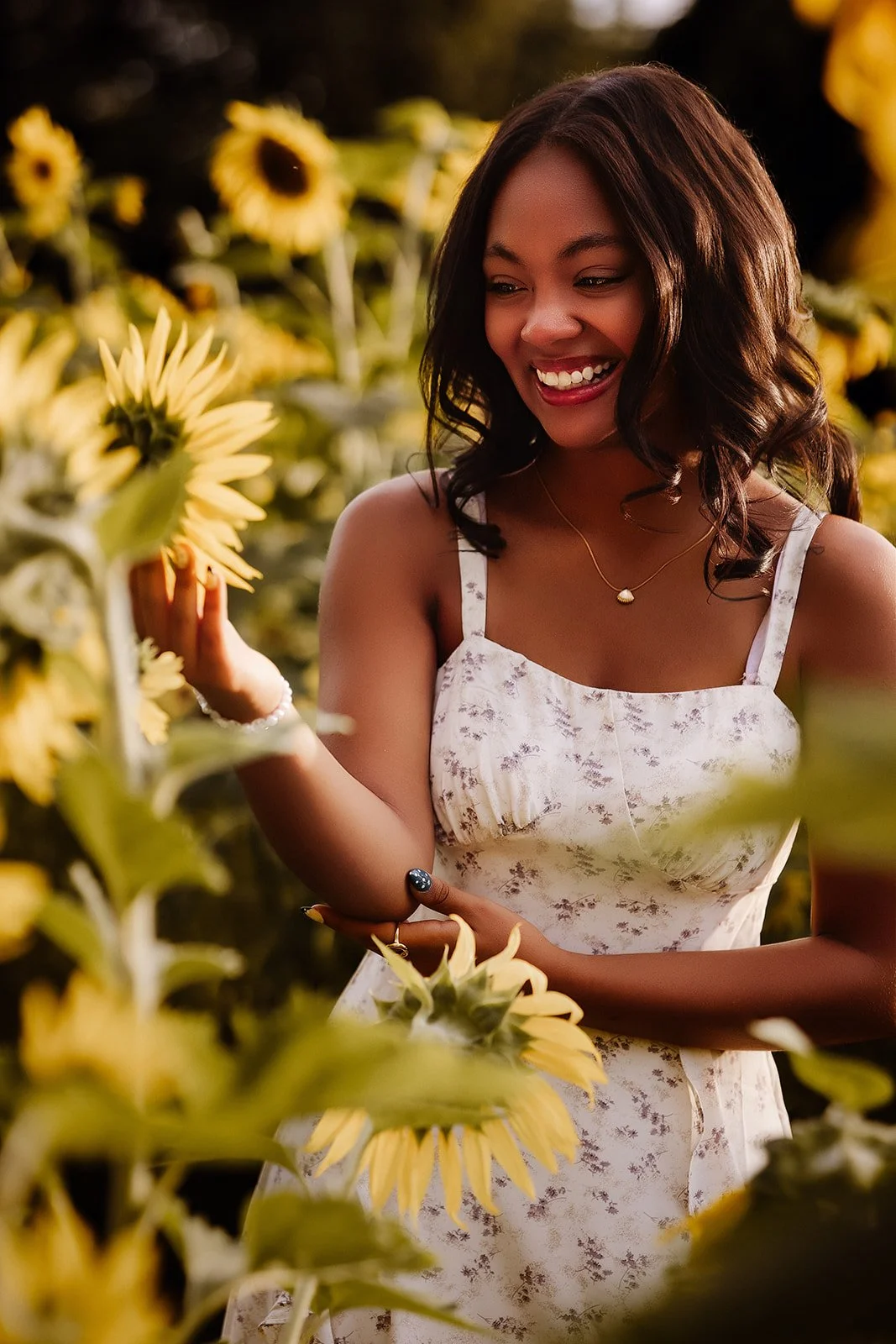 Senior portrait in sunflower field.