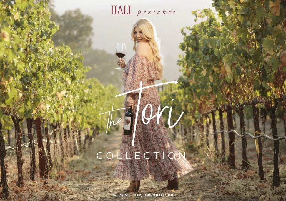 Advertising campaign photo for Hall Wines Tori Spelling Collection featuring a woman in a floral dress walking through a Napa Valley vineyard at golden hour – Marc Olivier Le Blanc Photography