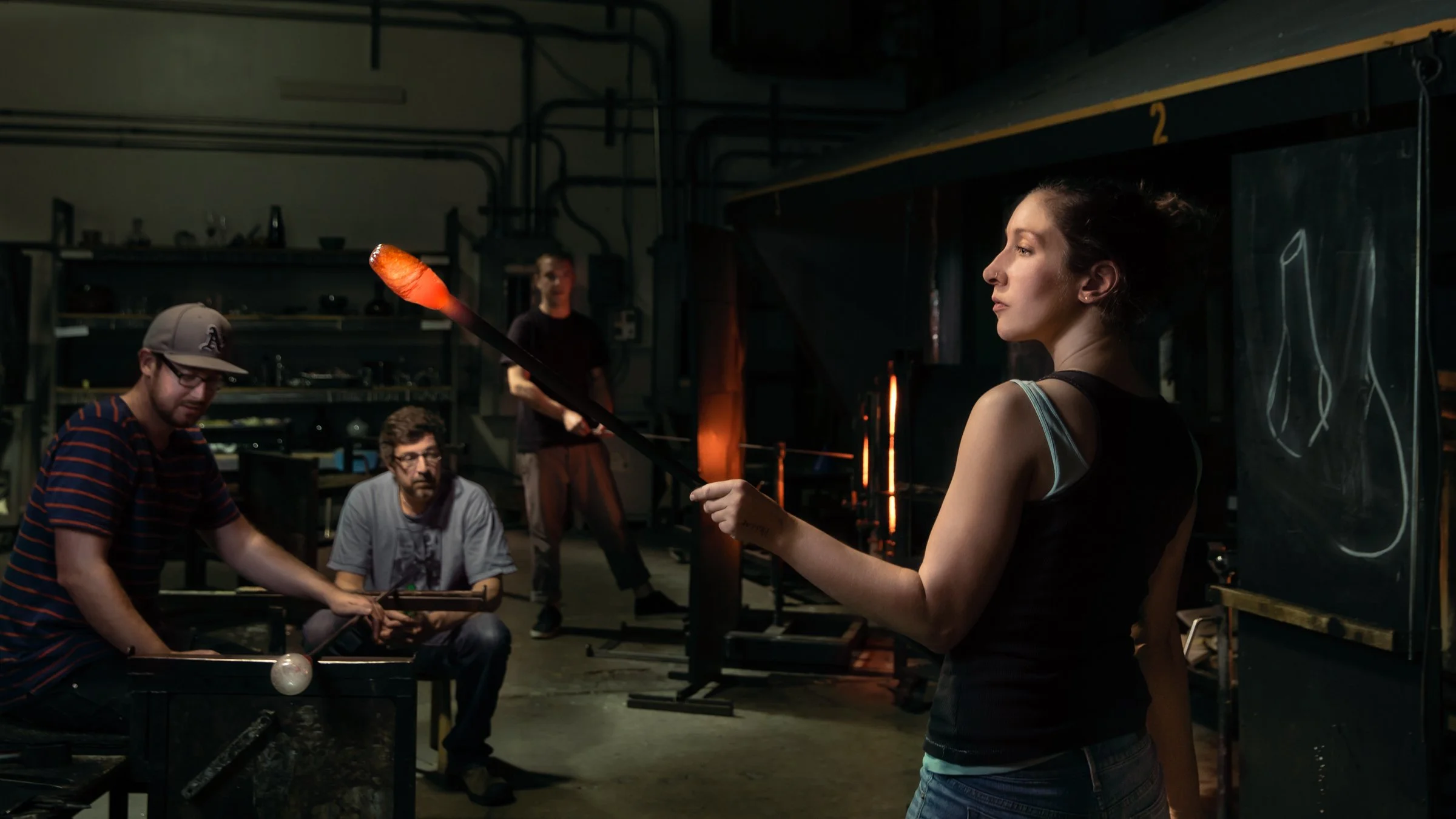 Glassblower shaping molten glass at the furnace at Public Glass, Bayview San Francisco, photographed by Marc Olivier Le Blanc