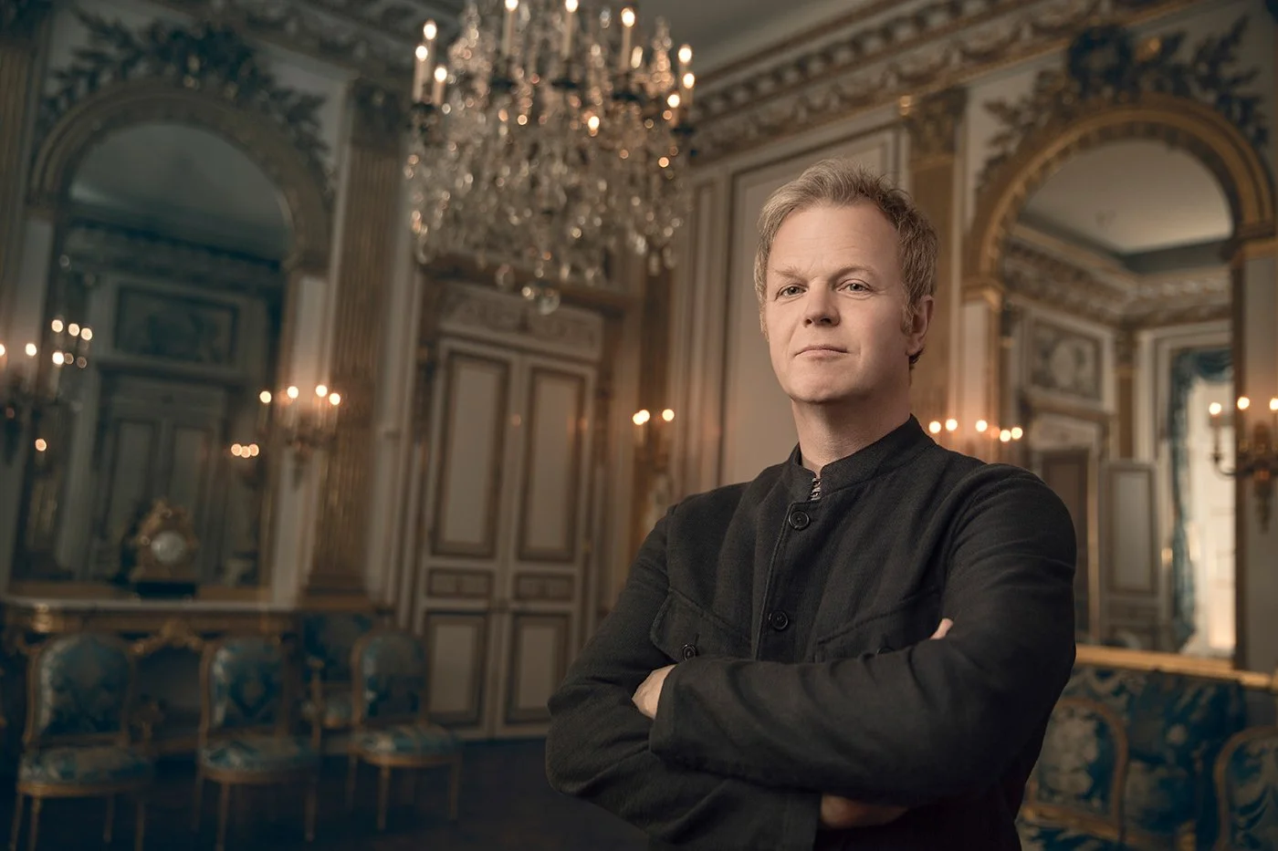 Master carver Adam Thorpe alongside his restoration work at the Salon Doré, Legion of Honor museum, San Francisco, photographed by Marc Olivier Le Blanc
