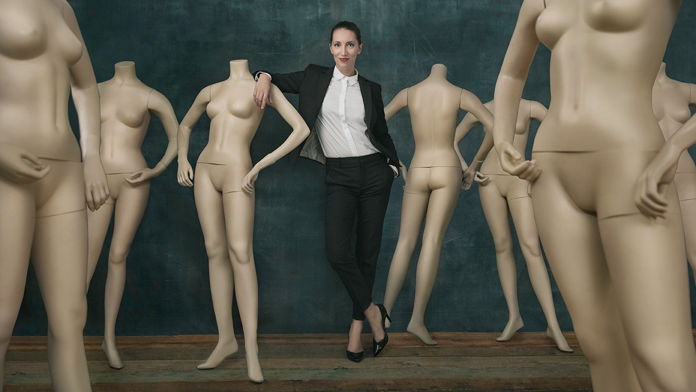 Concept portrait of actress Maxine Wulf in formal suit among studio mannequins, by San Francisco portrait photographer Marc Olivier Le Blanc