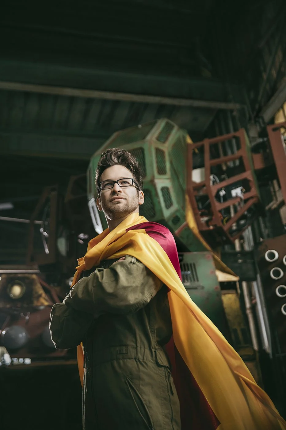 Environmental portrait of robotics engineer with giant fighting robot, Bay Area editorial photography