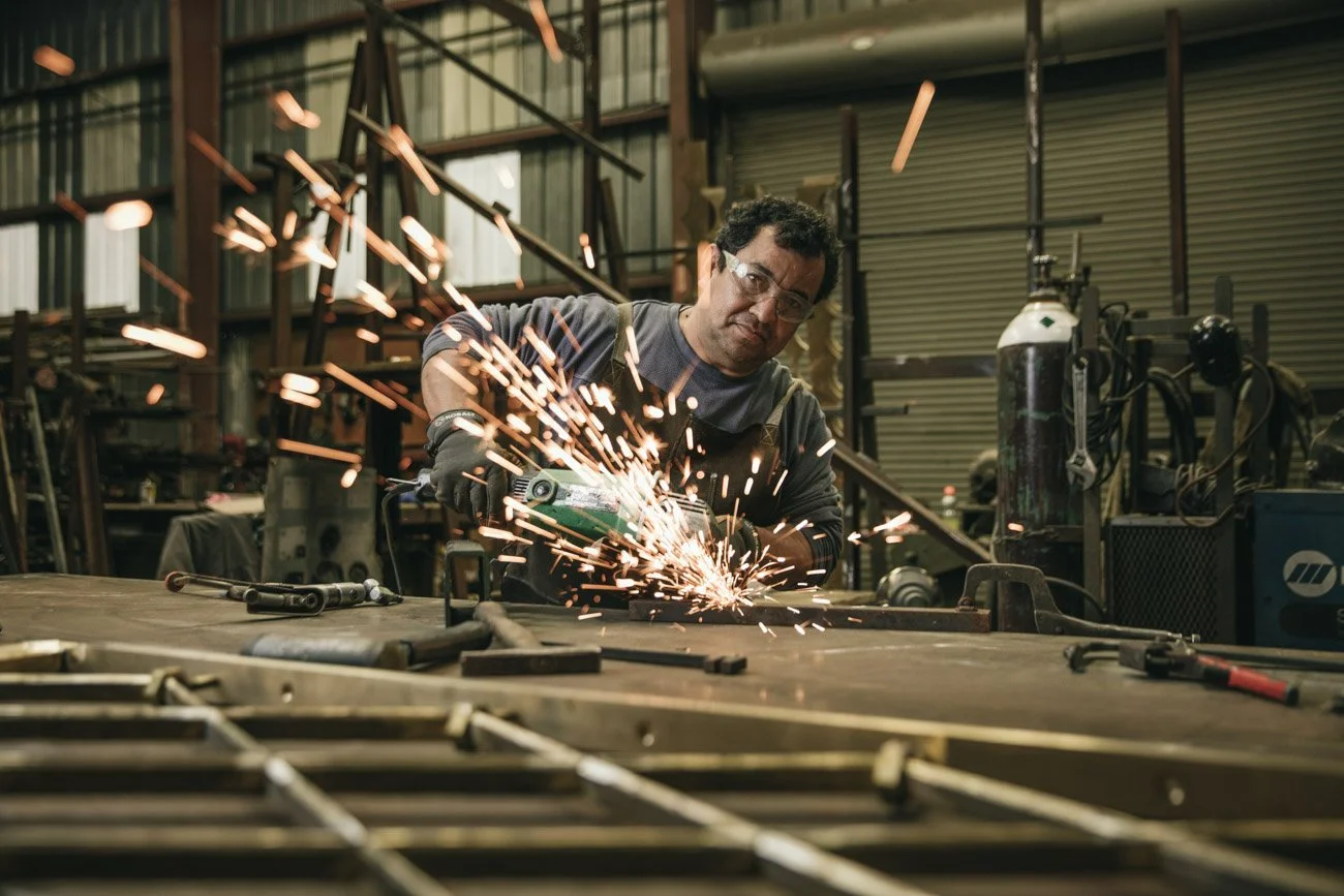 Environmental portrait of metalworker at forge, San Francisco Bay Area editorial photography