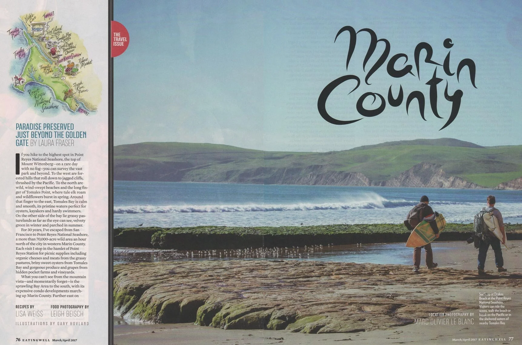 Two surfers walking on the beach with surfboards, overlooking the ocean near Point Reyes in Marin County, California.