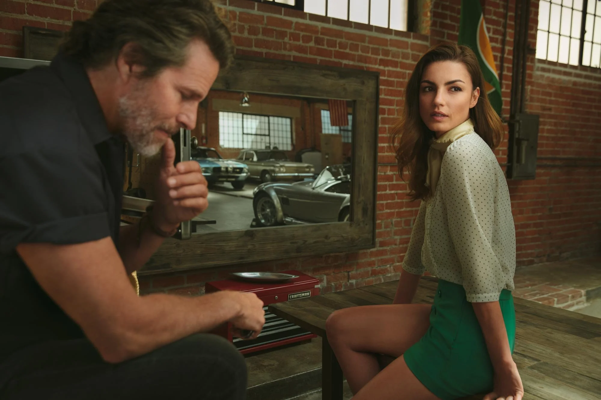 Portrait of model with vintage race car in Los Angeles Chinatown garage, commercial photographer Marc Olivier Le Blanc