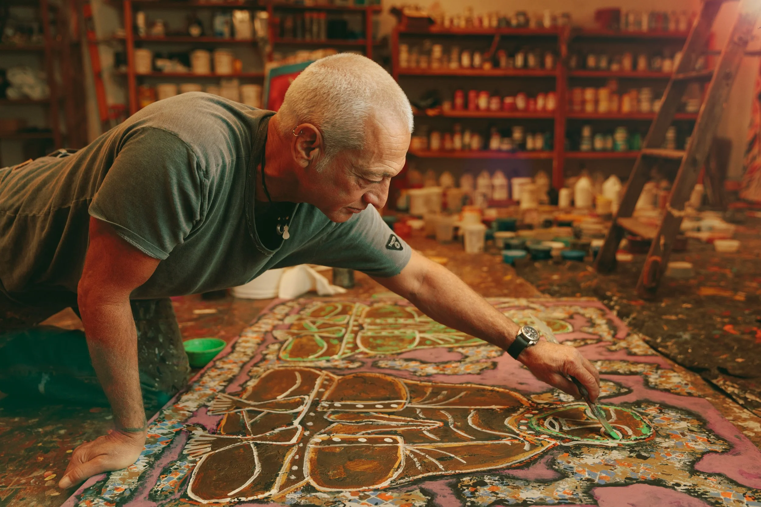 Editorial portrait of a painter working on a large canvas on the floor of his San Francisco studio – Marc Olivier Le Blanc Photography