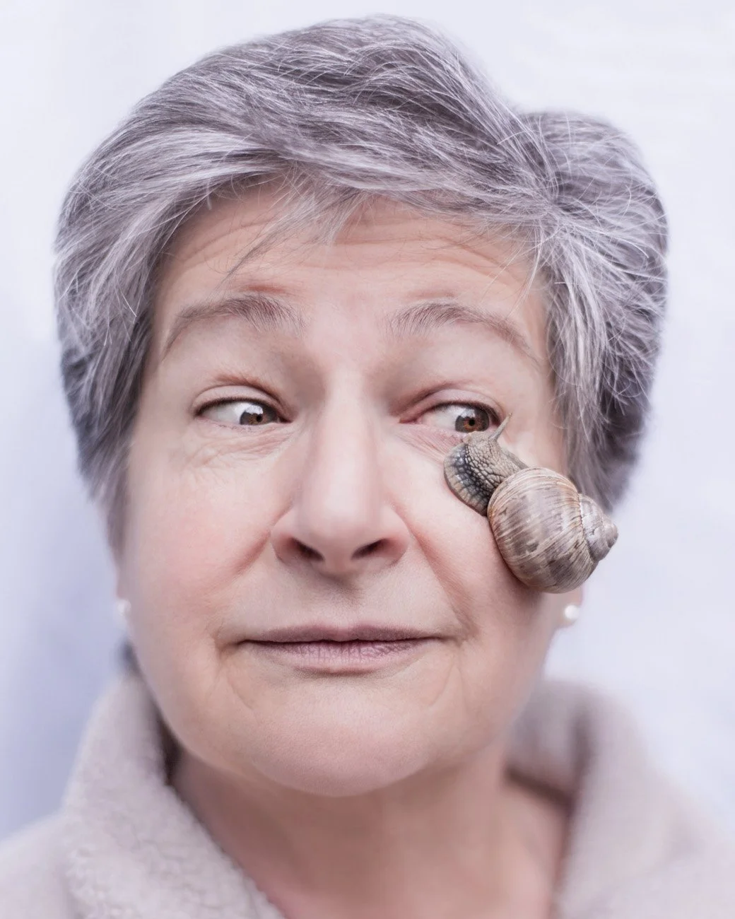 Editorial studio portrait of a woman with a snail on her face, San Francisco – Marc Olivier Le Blanc Photography