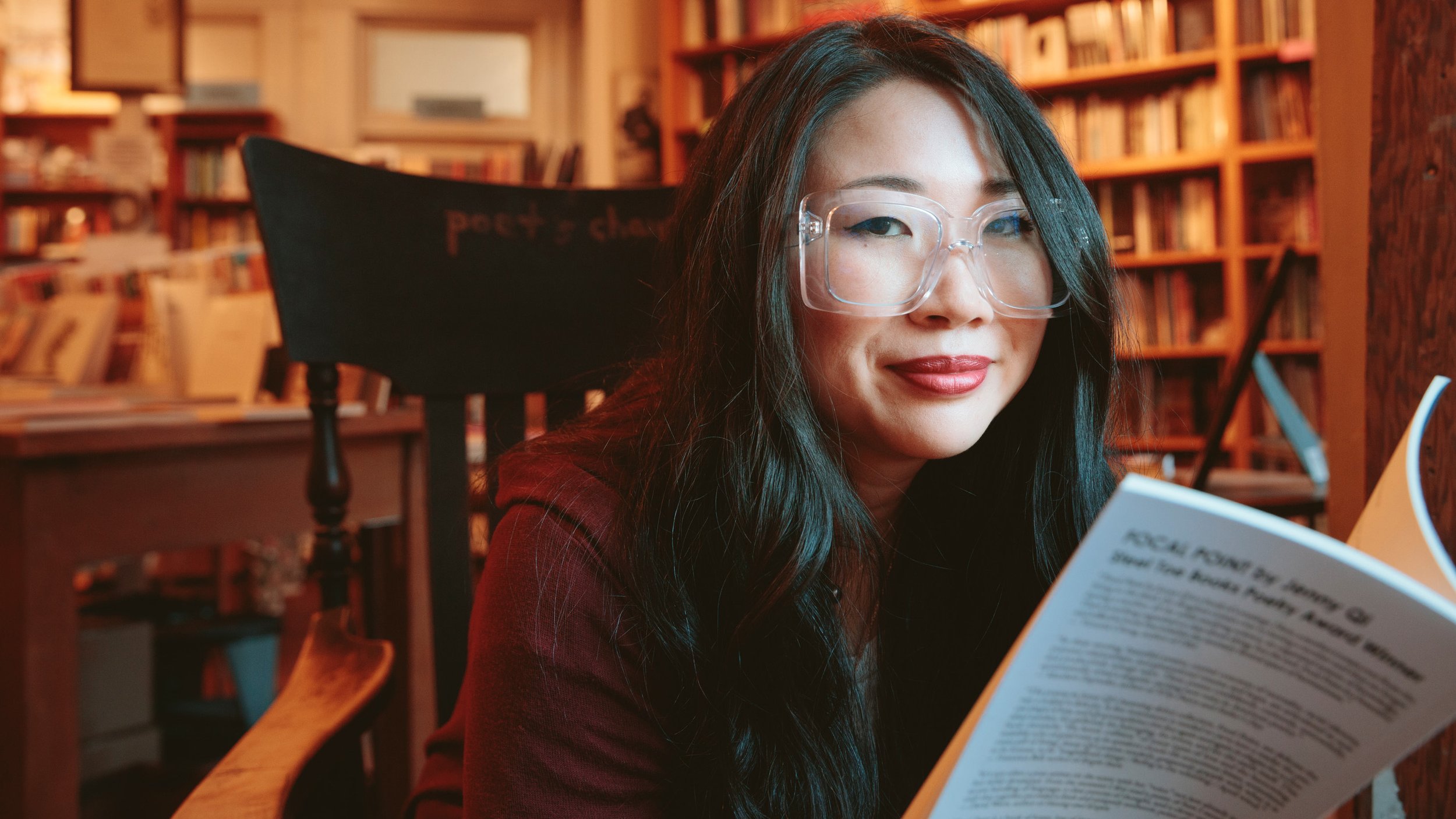Lifestyle portrait of a woman reading in a warmly lit San Francisco bookstore – Marc Olivier Le Blanc Photography