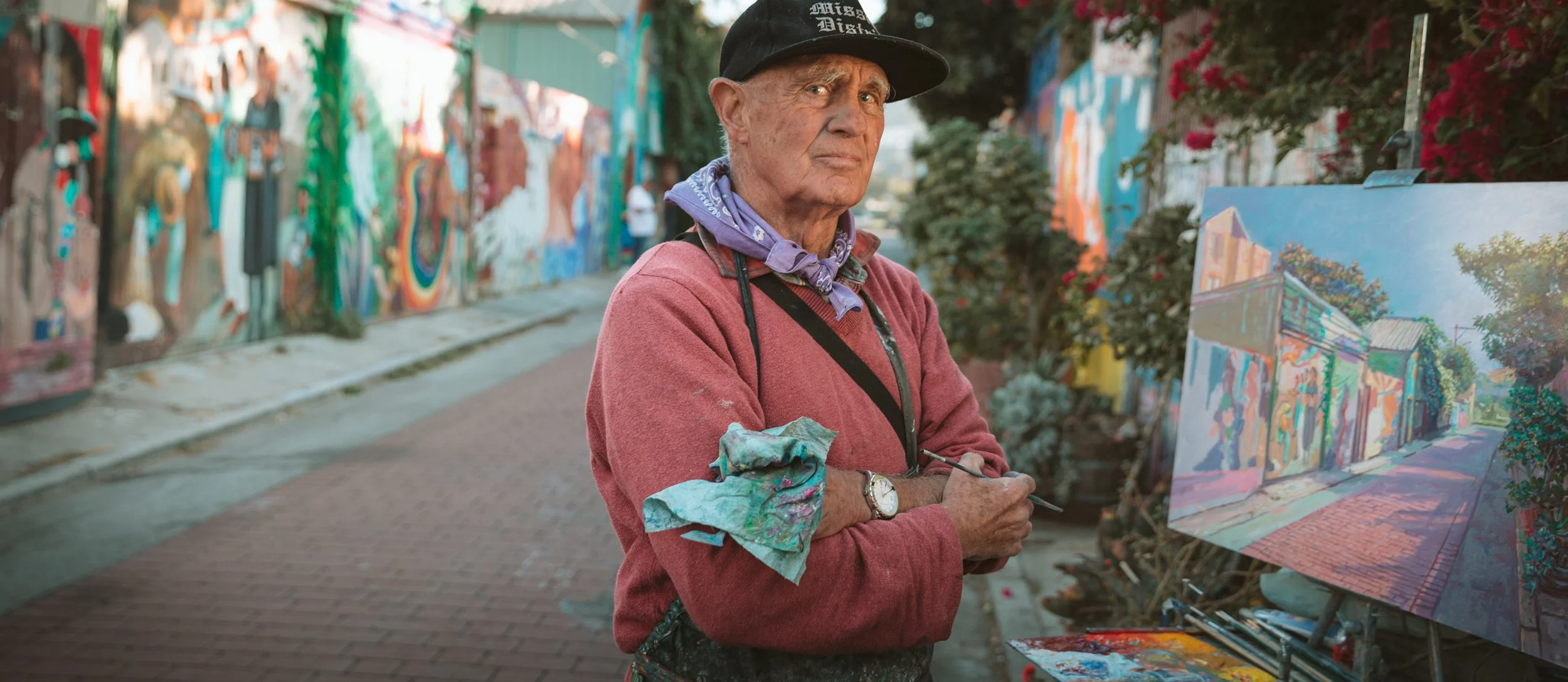Editorial portrait of an elderly street painter with his canvas in the colorful Mission District of San Francisco – Marc Olivier Le Blanc Photography