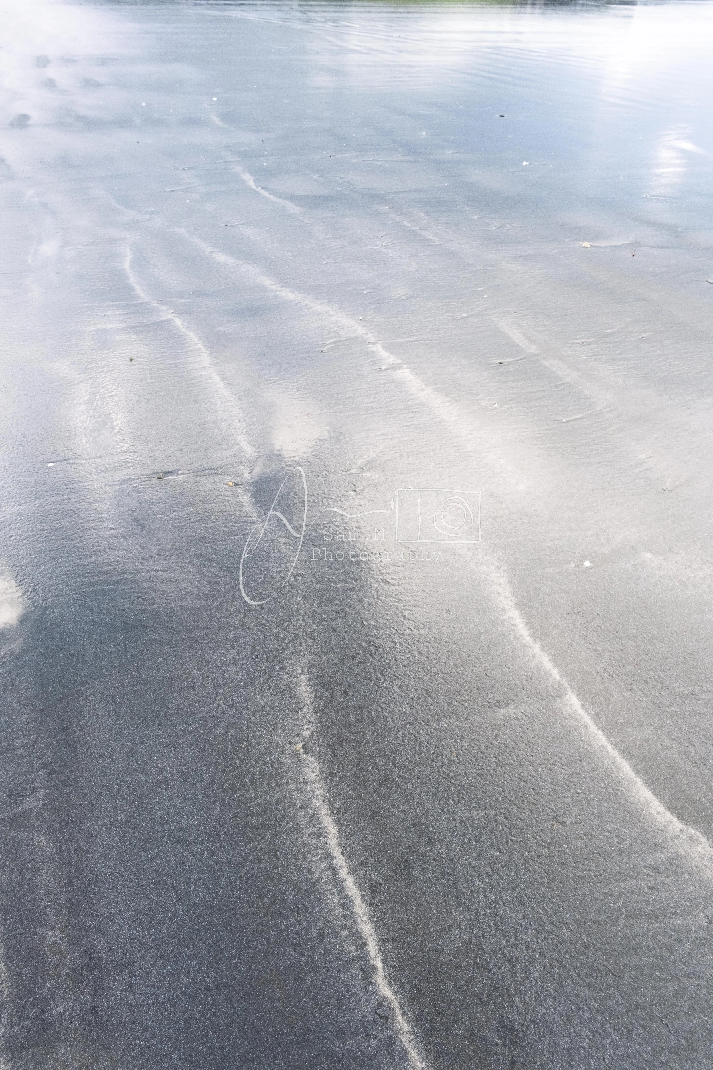 Snow-covered ground with visible tire tracks or marks in the snow.