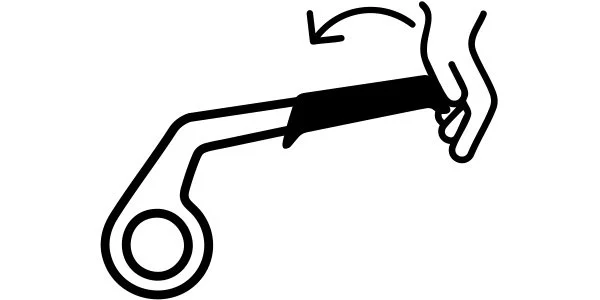 A hand holding a shoehorn, inserting the heel of a shoe