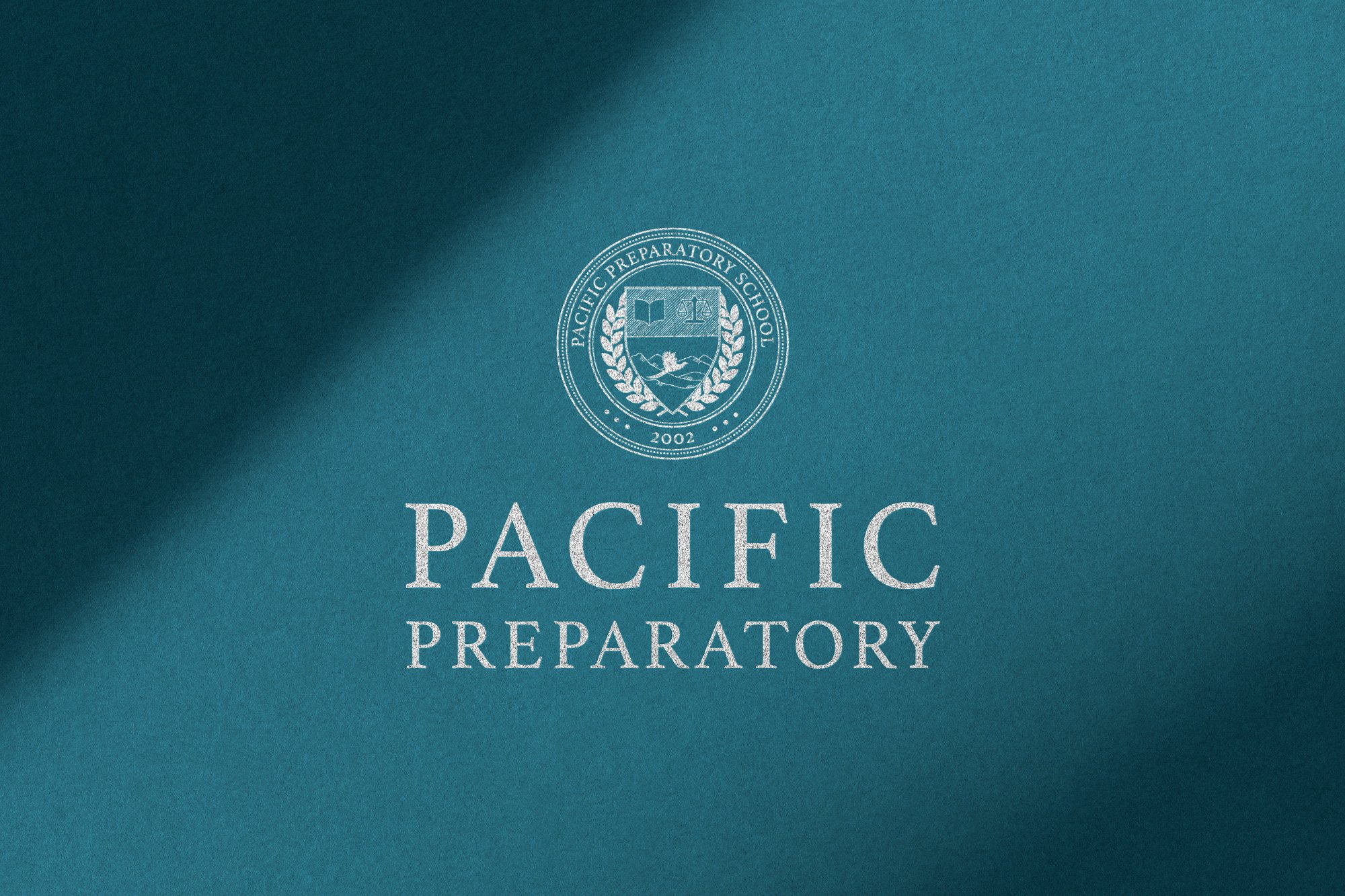 A teal-colored book cover with a white emblem and text for Pacific Preparatory, including the year 2002, indicating it's an educational institution.