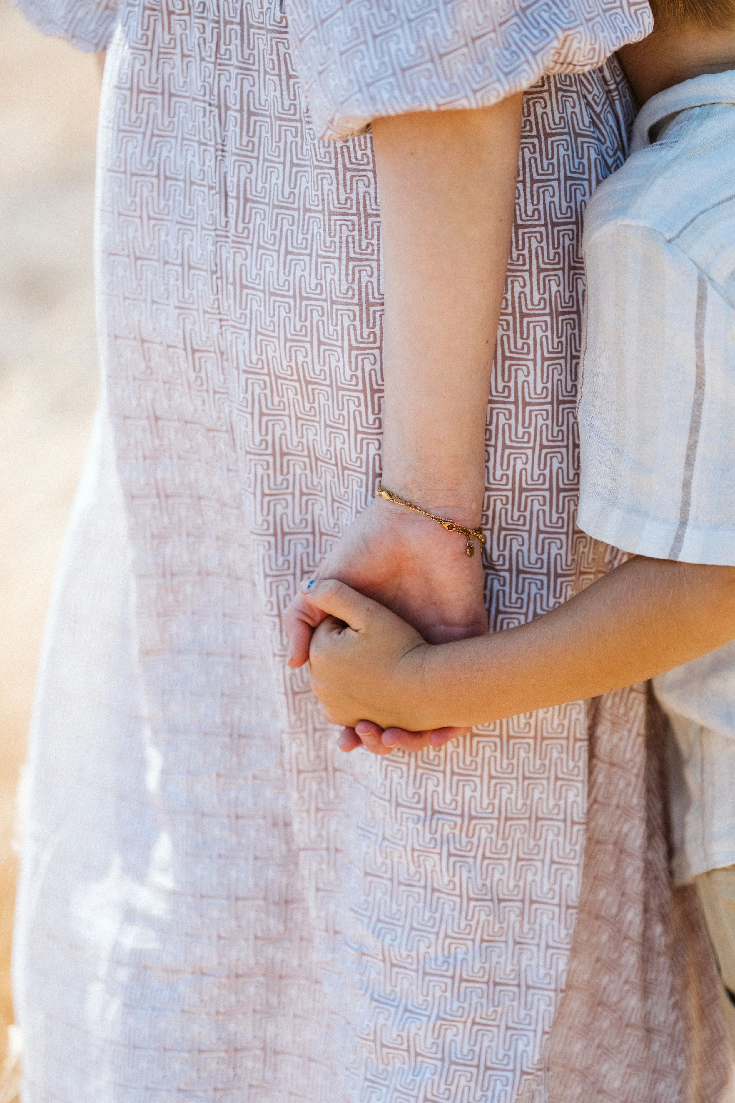 Parent and child holding hands, representing support through parenthood