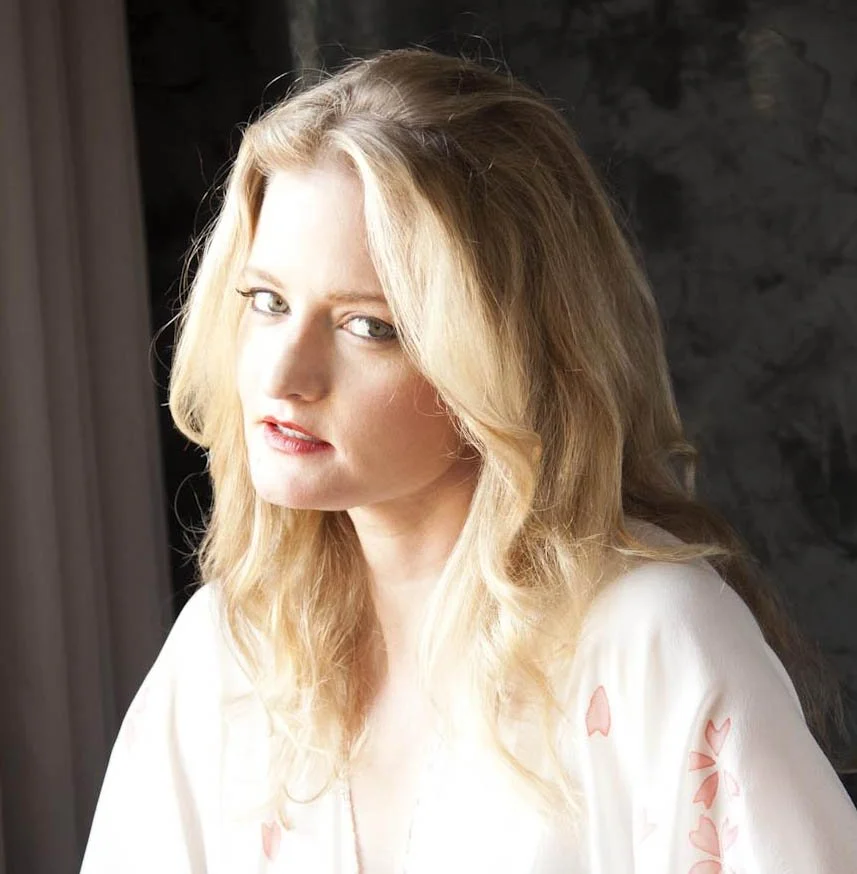 Headshot of Mary Cunningham in a light dress and light background