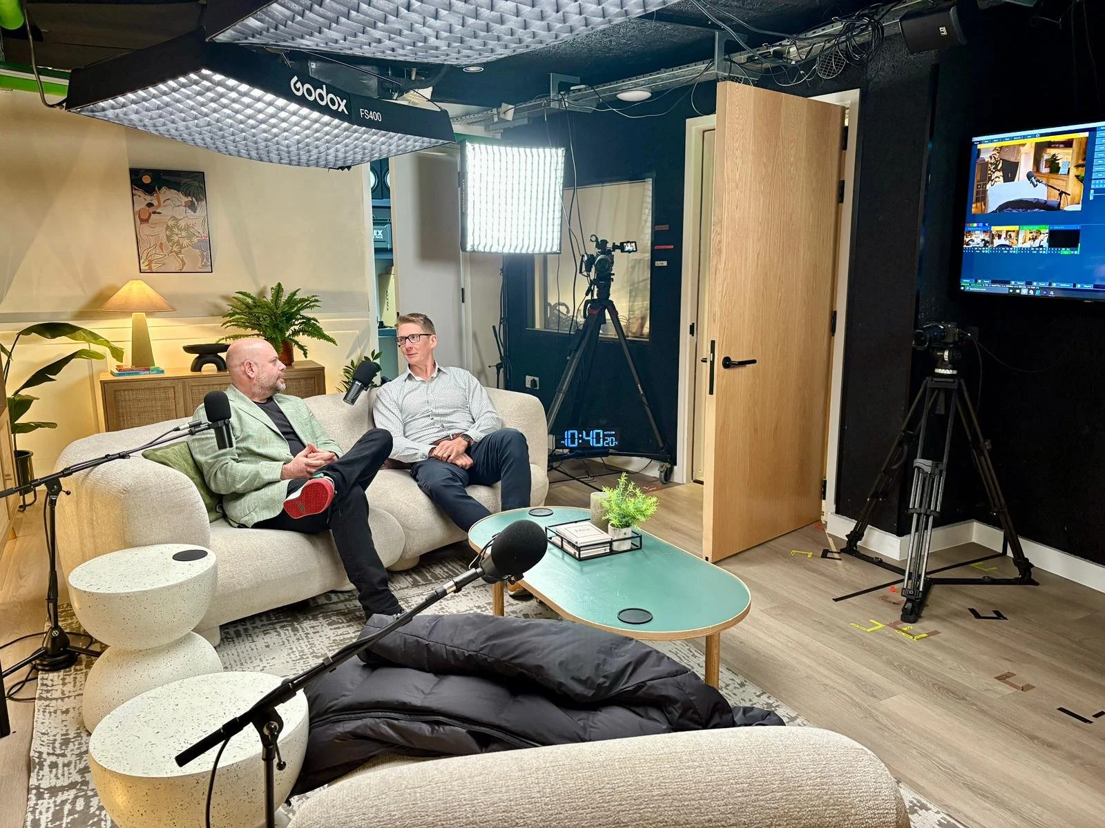 Ian and James on sofa filming podcast