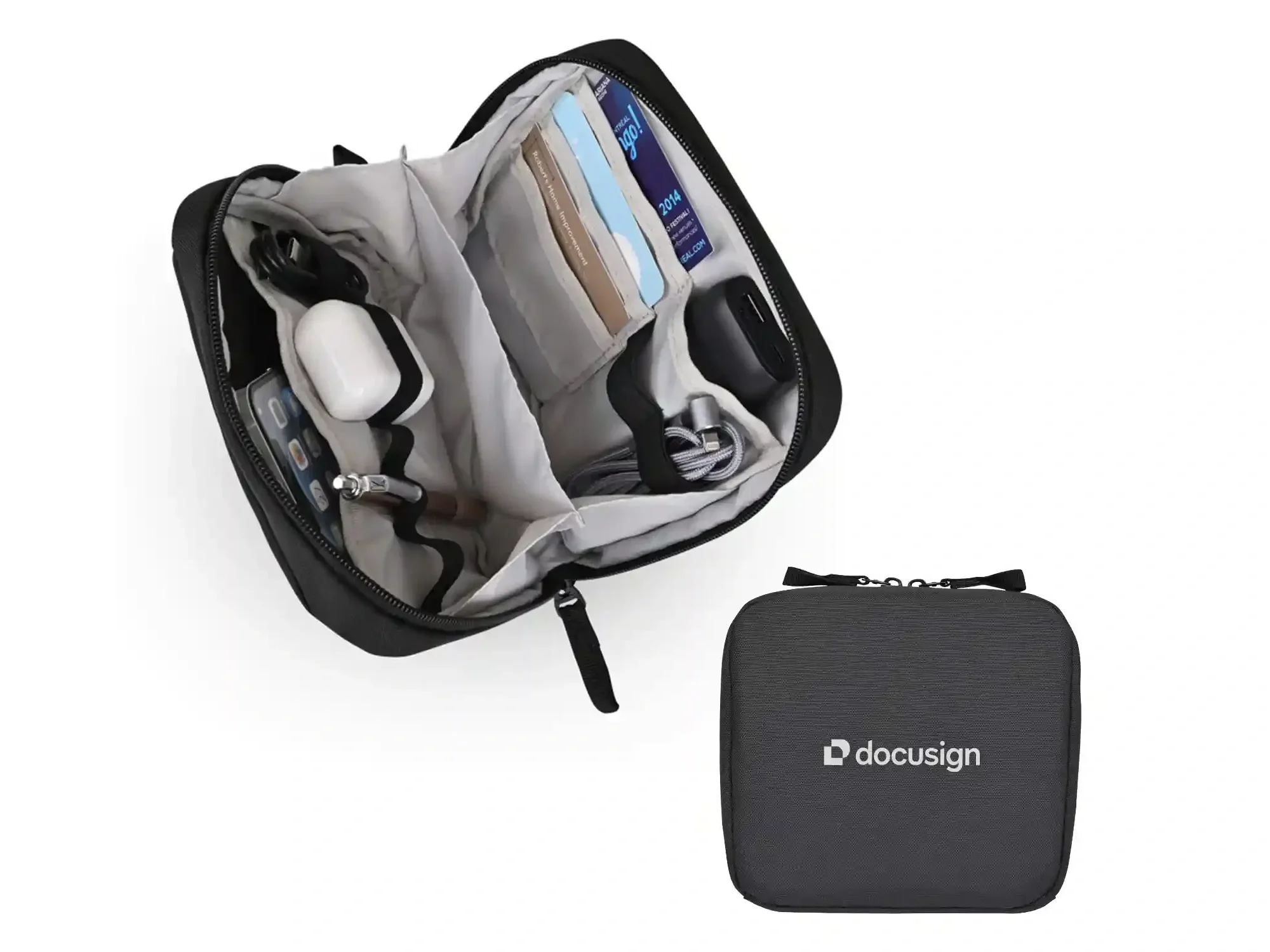 Open black travel bag with various items and a closed black case with custom logo