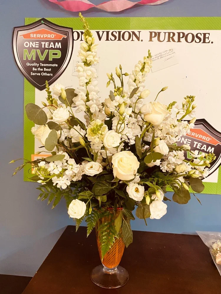 glass orange vase with white flower bouquet